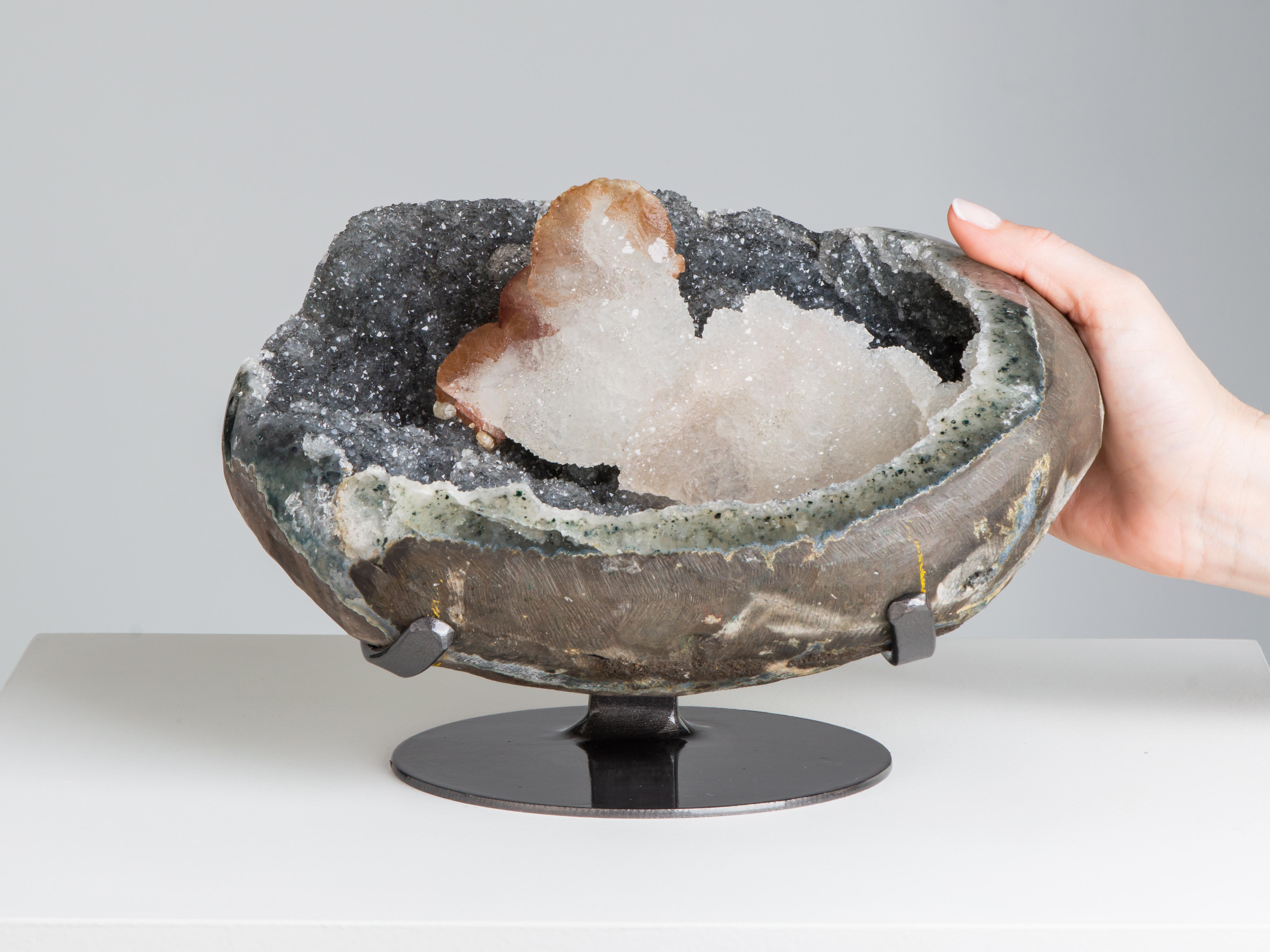 A wonderful largely complete geode lined with steel coloured druzy quartz and a large central calcite covered in white druze, resembling a bellowing smoke cloud. To the side the flame like underlying calcite can be seen.

Dimensions of stone : H