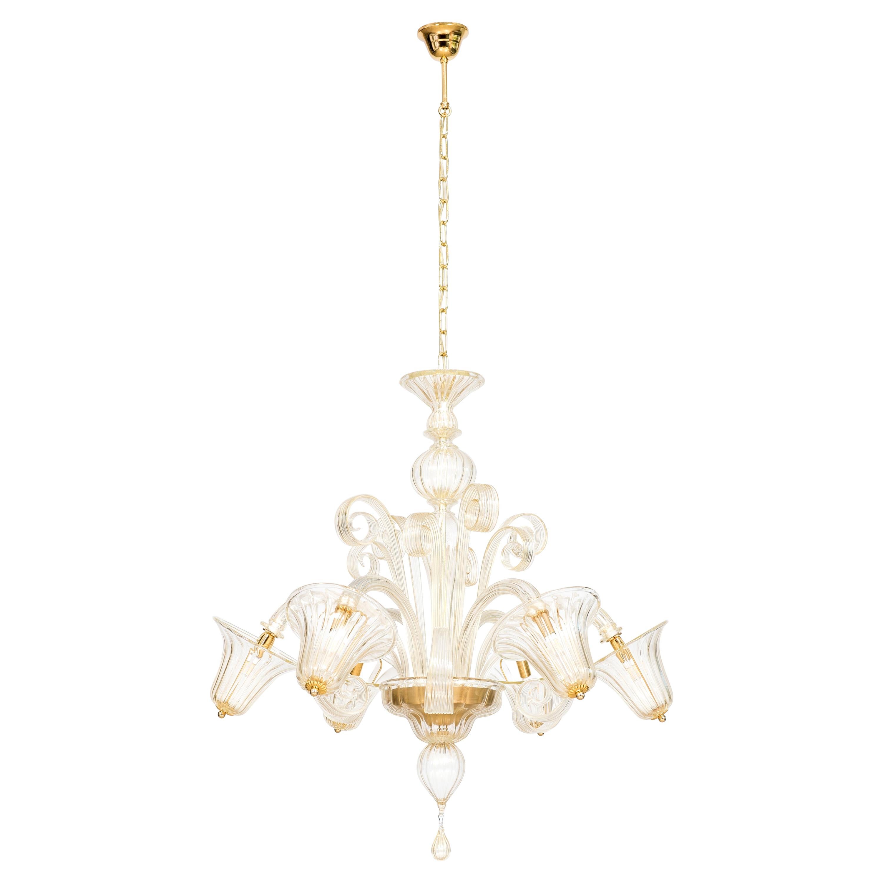 Bells and Pastorals chandelier blown murano glass gold color contemporary, Italy.
This outstanding Venetian chandelier is a tribute to beauty and elegance. The central holder sustains six bowed arms with their lights, enveloped by transparent light