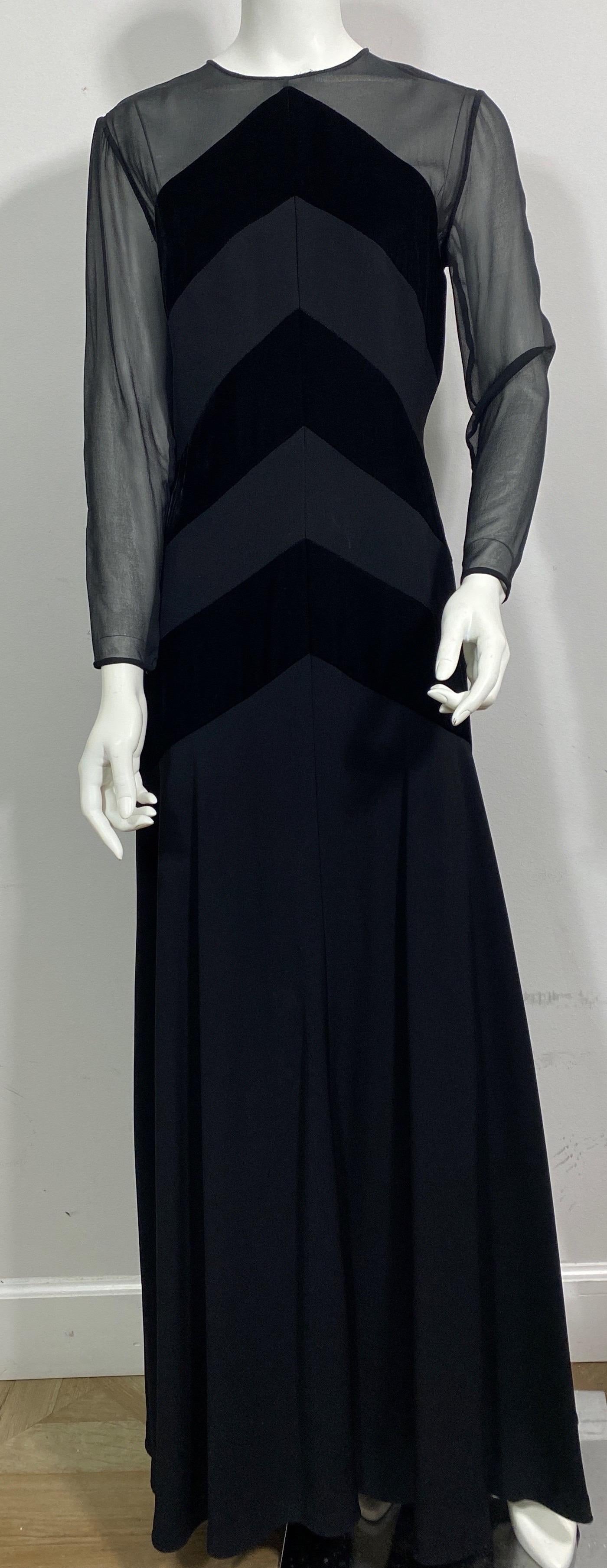 Bellville Sassoon 1990’s Black Long Sleeve Gown - Size 8  This 1990’s gown is made of a poly blend fabric but gives the appearance of silk, velvet and crepe. The gown is fitted to the hip area and then does a gradual flare to a flow skirt towards