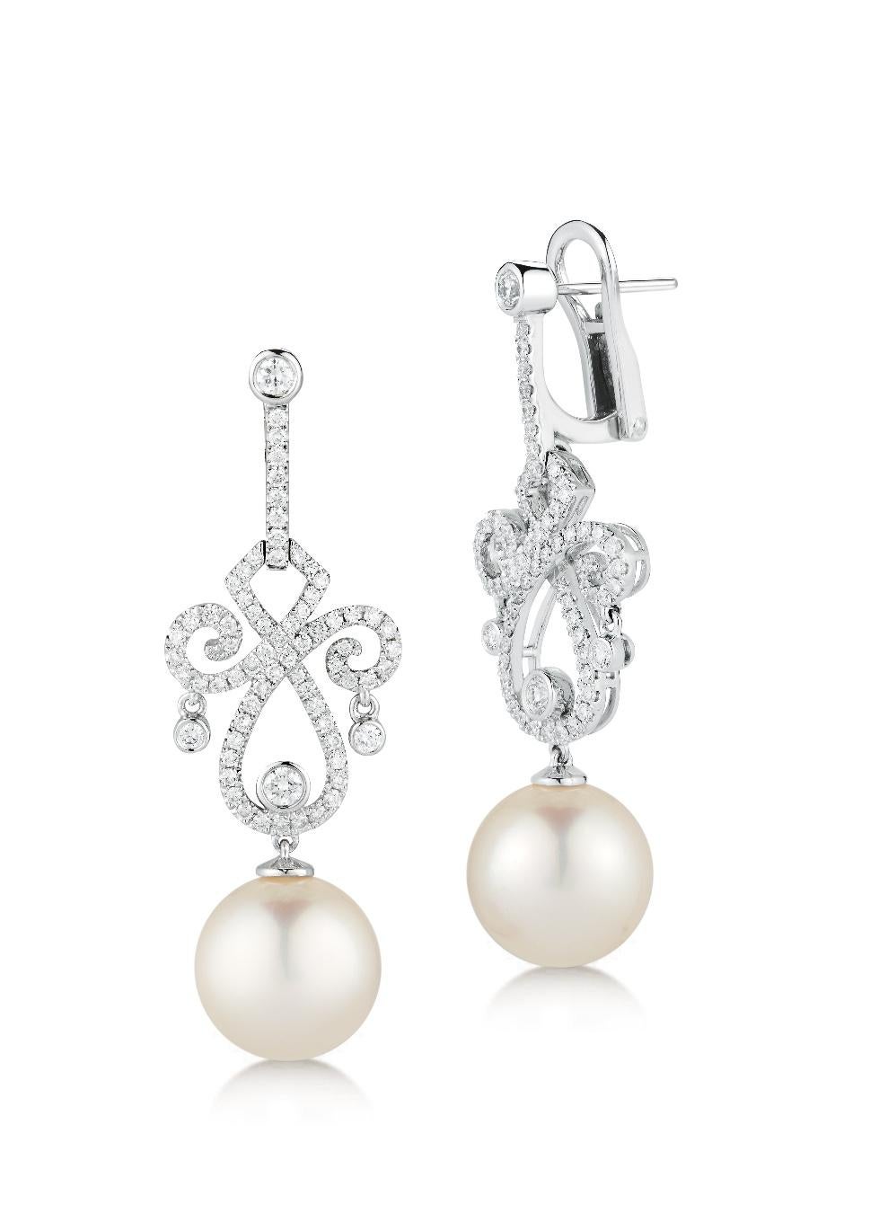 13mm Round White South Sea pearls dangling gracefully from a diamond swirl frame of 18-karat white gold, studded with white diamond pavé.

-18K White gold 
-1.34 Total Carat Weight
-13mm White South Sea Pearls
-Post and clip
-Made in USA

