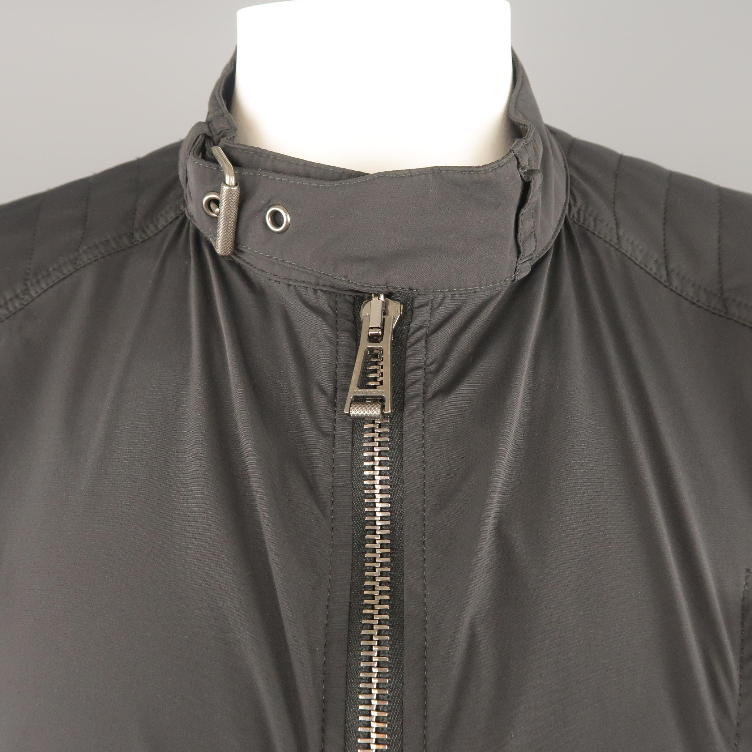BELSTAFF jacket comes in black nylon with a band belt collar, double zip front, and zip pockets. Made in Romania.
 
Very Good Pre-Owned Condition.
Marked: IT 54
 
Measurements:
 
Shoulder: 19 in.
Chest: 44 in.
Sleeve: 26 in.
Length: 27 in.