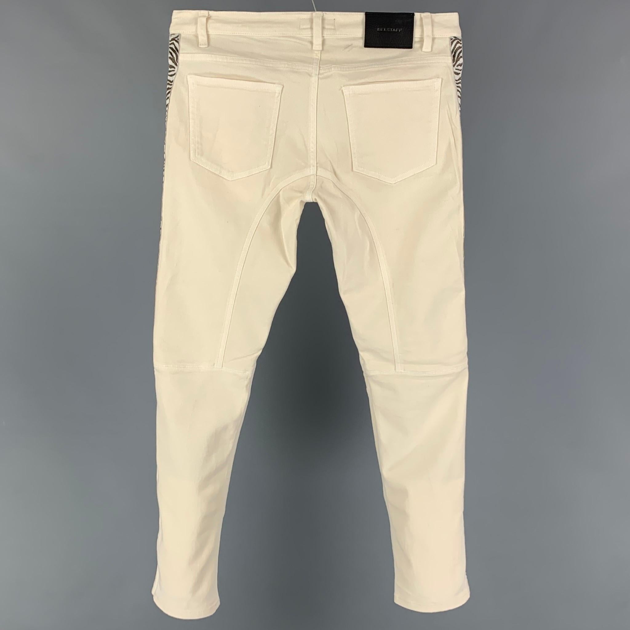 BELSTAFF jeans comes in a cream & brown cotton blend featuring a slim fit, low rise, animal print trim, ribbed panel, and a zip fly closure. 

Very Good Pre-Owned Condition.
Marked: 30/33

Measurements:

Waist: 30 in.
Rise: 9.5 in.
Inseam: 30 in. 