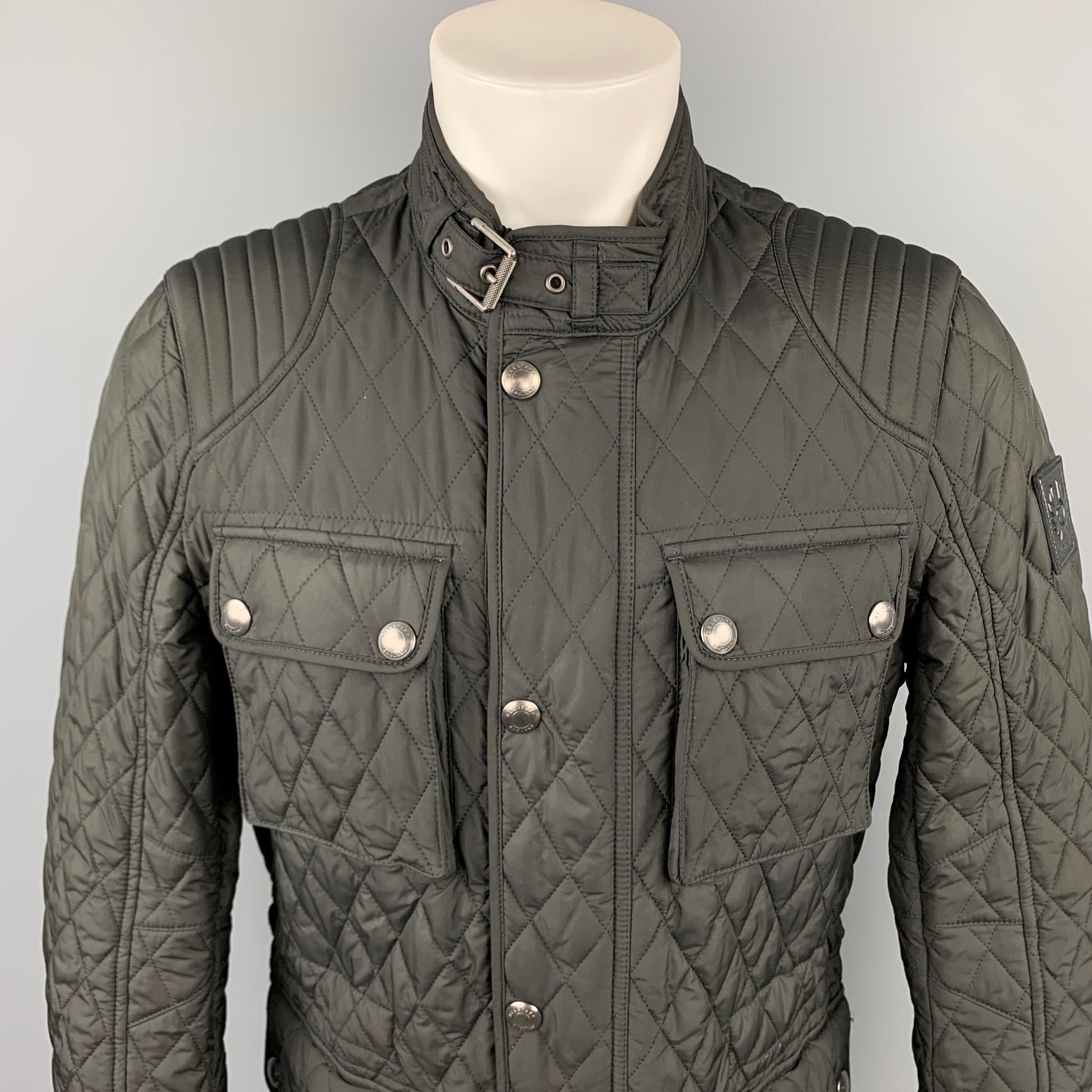 BELSTAFF jacket comes in a black quilted polyester with a plaid liner featuring patch pockets, strap collar, and a zip and snap button collar. Made in Bulgaria.

Very Good Pre-Owned Condition.
Marked: 50

Measurements:

Shoulder: 18 in.
Chest: 42