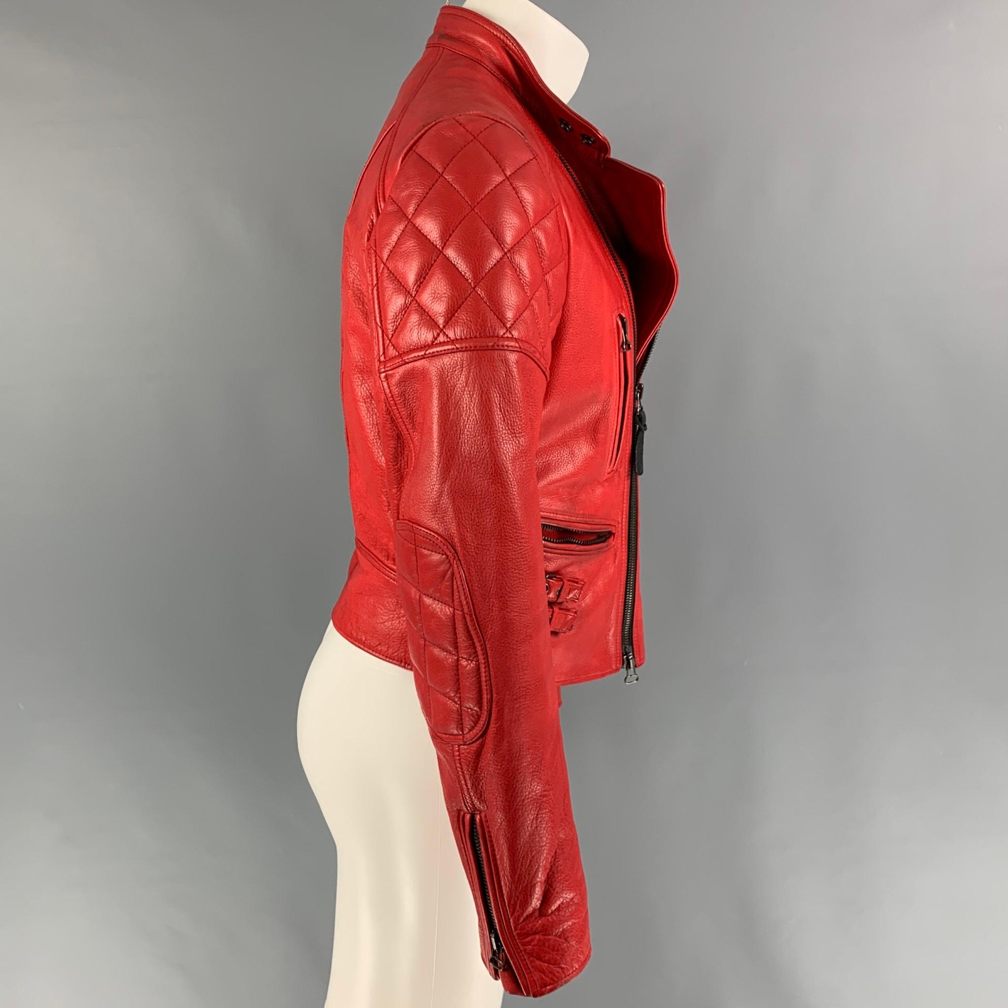 BELSTAFF 'Racing Perfecto Blouson' jacket comes in a red leather with a full liner featuring a motorcycle style, quilted panels, zipper pockets, strap details, zipped cuffs, snap button collar detail, and a full zip up closure. 

Very Good Pre-Owned