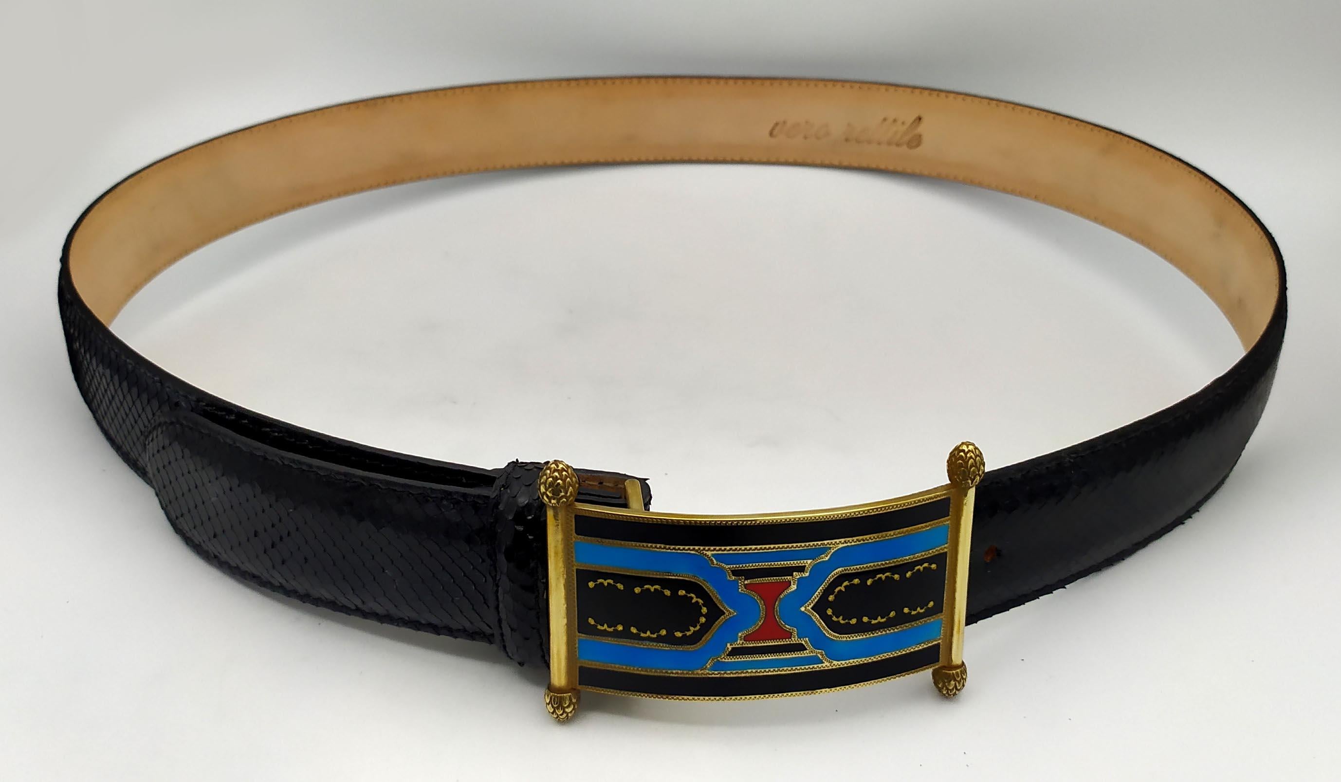 Belt in real black python reptile with rectangular buckle in 925/1000 gold-plated silver with columns, with Art Deco design fire-enamelled in 3 colors enriched with pure gold sequins. Dimensions cm. 5.8 x 8.5. Weight gr. 70. Designed by Giorgio