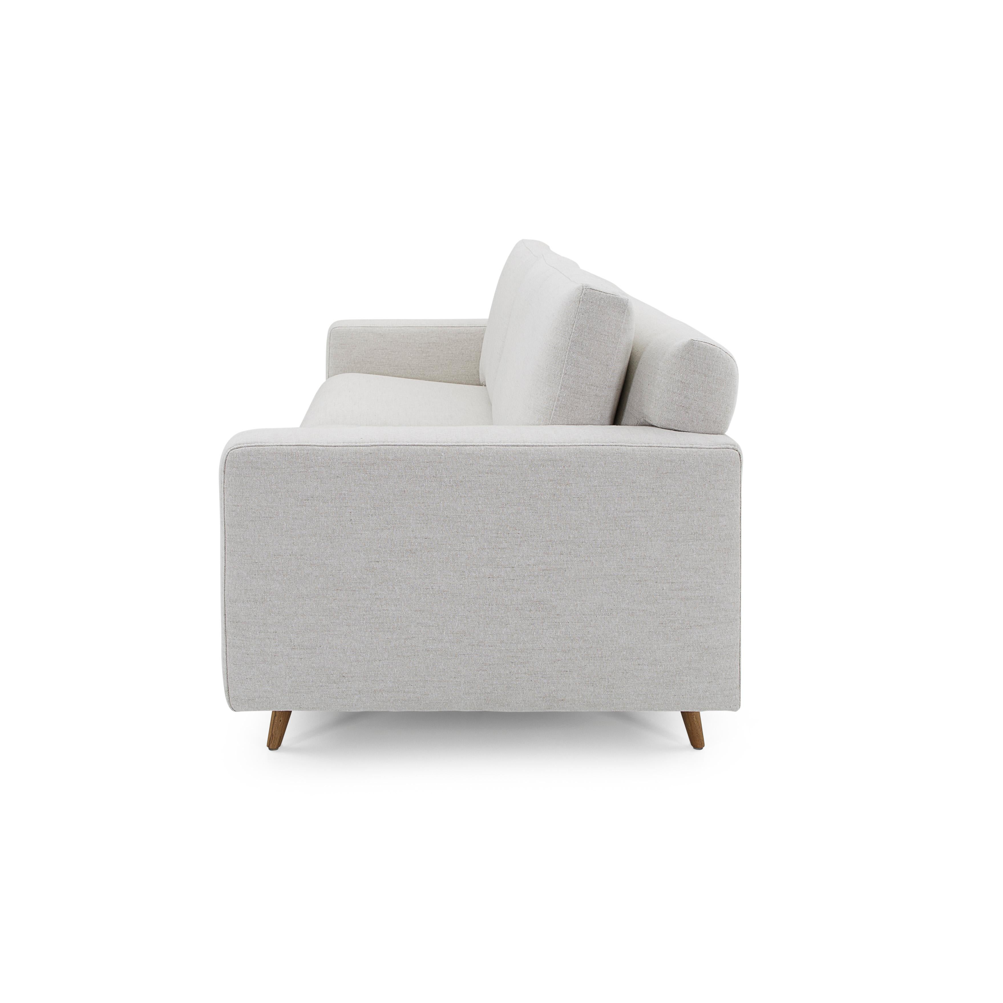 The Belt sofa with detailed arms inspired by the highest European seams, upholstered in a stunning off-white fabric, and its teak wood finish legs, is here for you and your family. As relaxing as it looks, the actual seat is even better. This sofa