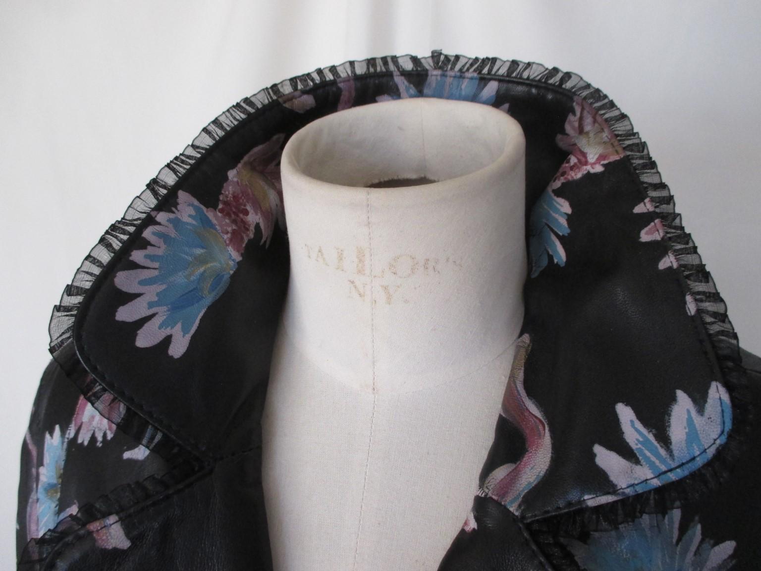 This is an exclusive black leather handpainted blue/pink flowers jacket

We offer more exclusive vintage items, view our frontstore.

Details:
Made of black leather, with blue and pink flowers
Embroidered with lace
With 3 Sr logo buttons, 2 pockets,
