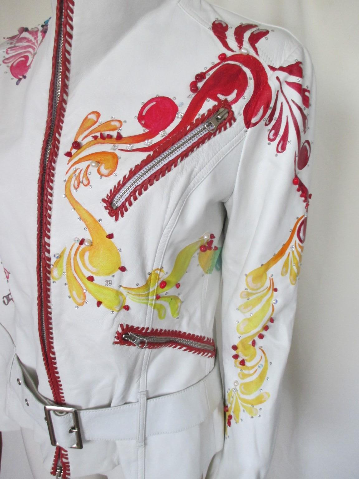 This is an exclusive white leather handpainted blue/pink flowers jacket

We offer more exclusive vintage items, view our frontstore.

Details:
Made of leather, with colorful flowers
Embroidered with pearls , stones , shells
With closing zipper, 4