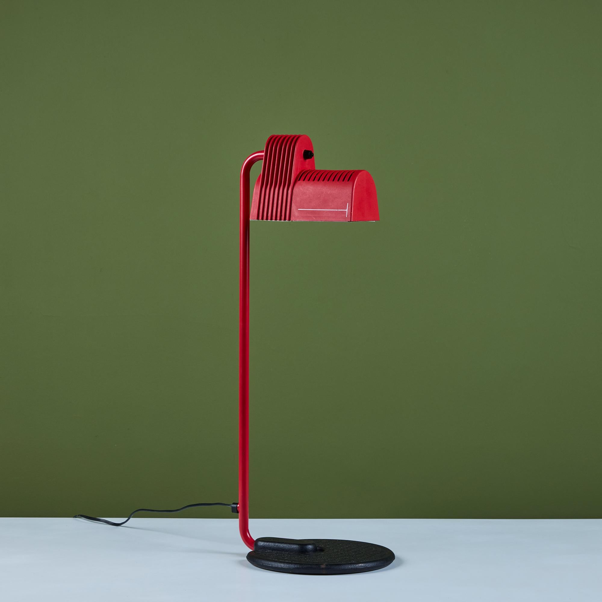 Industrial table lamp by Guillermo Capdevila, c.1980s, Spain. It features a red plastic pivoting shade for directional lighting with a metal red enameled stem and round black enameled base with waffle detailing.

Dimensions
9