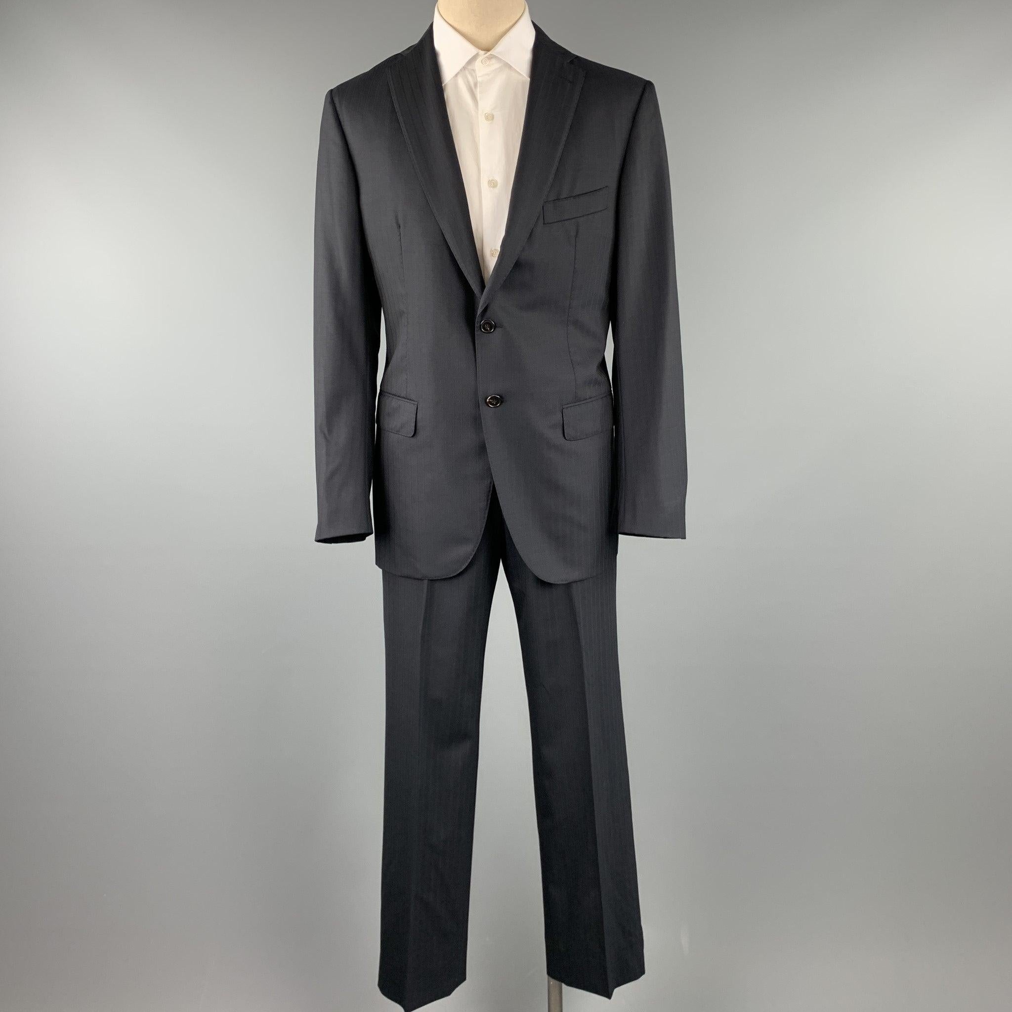 BELVEST suit comes in a black stripe wool with a full monogram print liner and includes a single breasted, two button sport coat with lapel and matching flat front trousers. Pin hole on sleeve back. As-Is. Made in Italy.
Good Pre-Owned Condition.