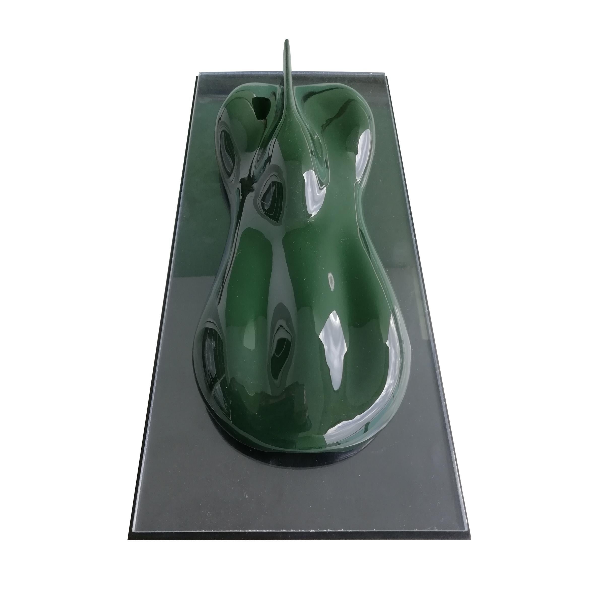 D type

A dark green lacquered and varnished marble composite model of a racing car.
On a lacquered rectangular wood base.

Belzoni finds inspiration in the legendary racing cars of the 1950s and the 1960s.
His elegant sculptures epitomize the
