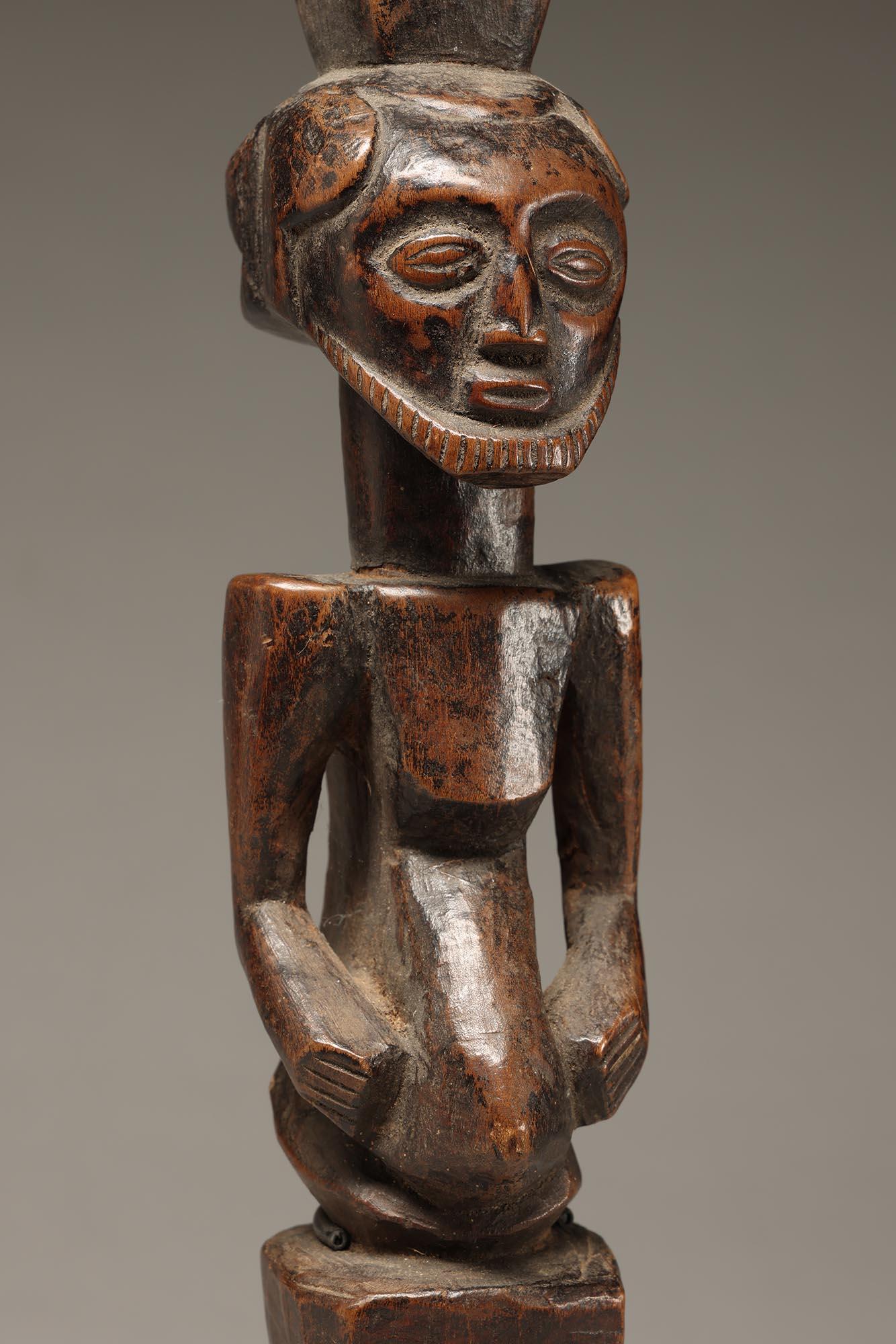 Striking Bembe bearded male bust figure with hands on sides of projecting stomach and finely carved beard.  Stacking square hair style on top of head and projecting element hair on back of head.  Classic Bembe form, on tapering square base, probably