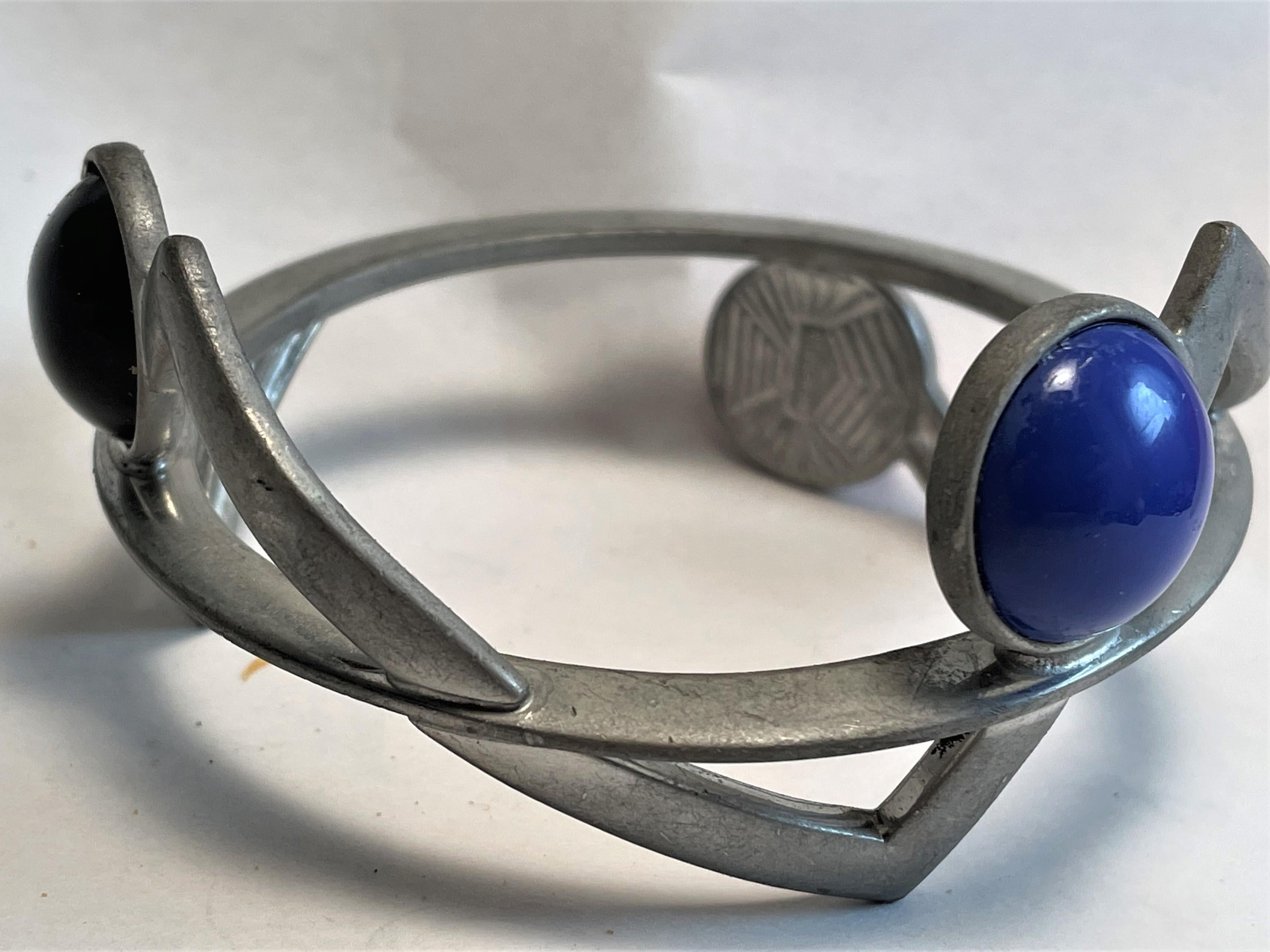 What a wonderful modernist, geometric bangle bracelet this is, because it has a dull gray finish on the outside and a shinier finish on the low spots of the inside, I think it's possible that the original finish has almost completely worn off, but I