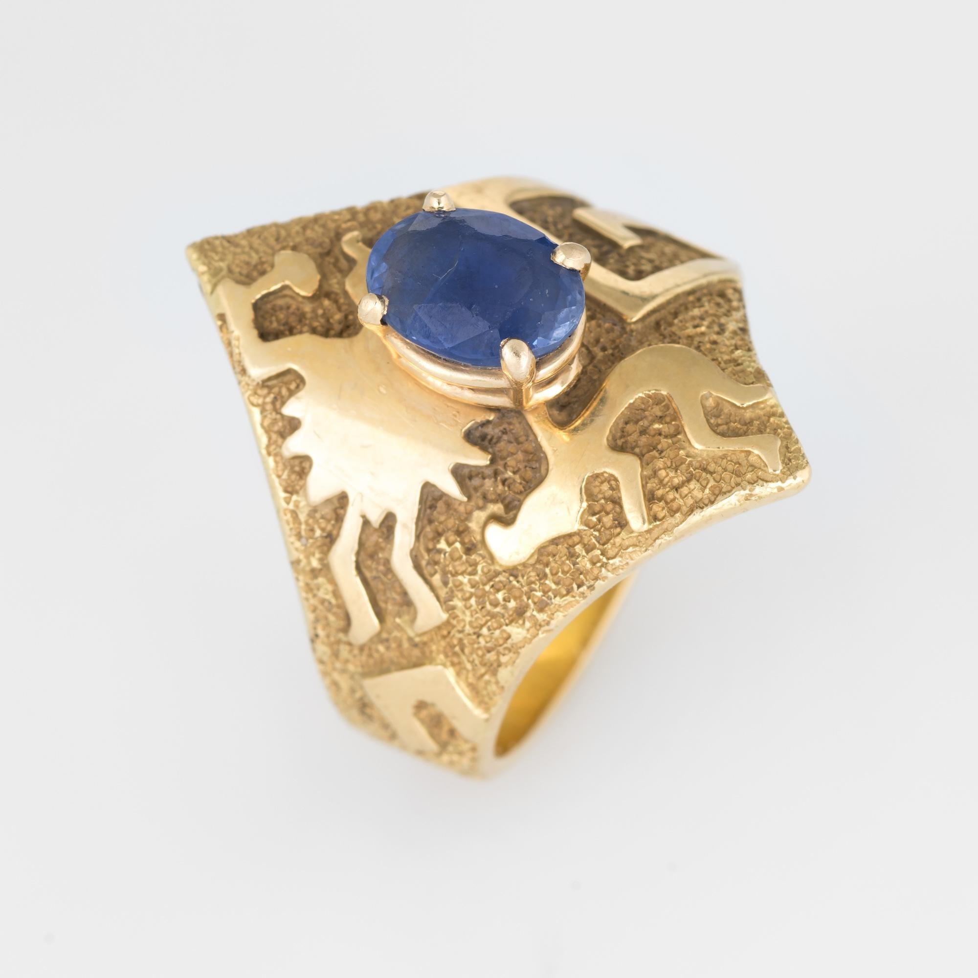 Stylish Ben Nighthorse sapphire ring crafted in 18 karat yellow gold.  

Oval faceted sapphire measures 7.8mm x 6mm (estimated at 1.60 carats). The sapphire shows surface abrasions visible under a 10x loupe.  

The distinct and unique ring is a