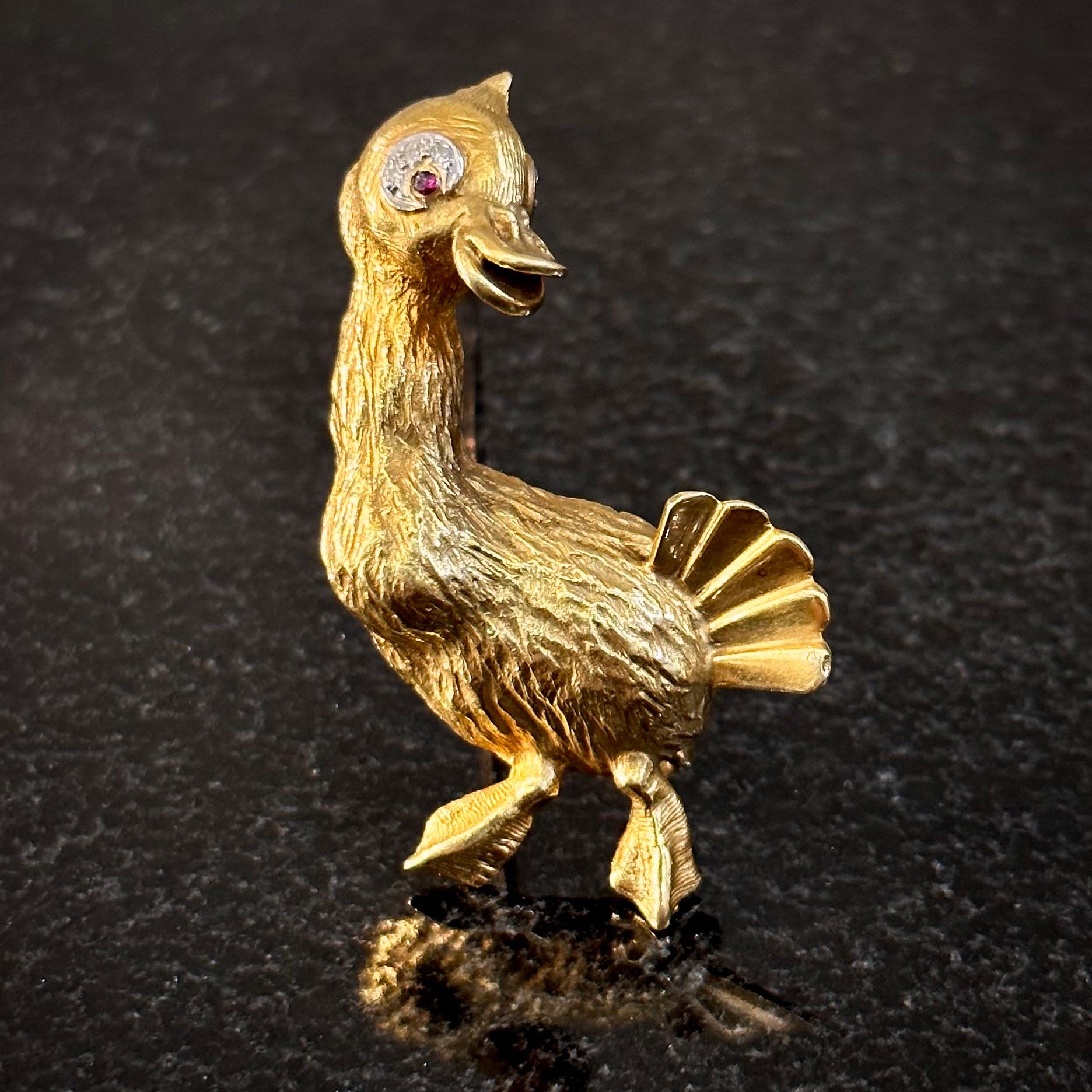 Ben Rosenfeld Mid-Century diamond and ruby duck brooch in 18kt yellow and white gold, English, 1960s. Made in 1961 and modelled as a mallard duck, the animal’s body in textured gold with a polished tail, the head and feet embellished with a