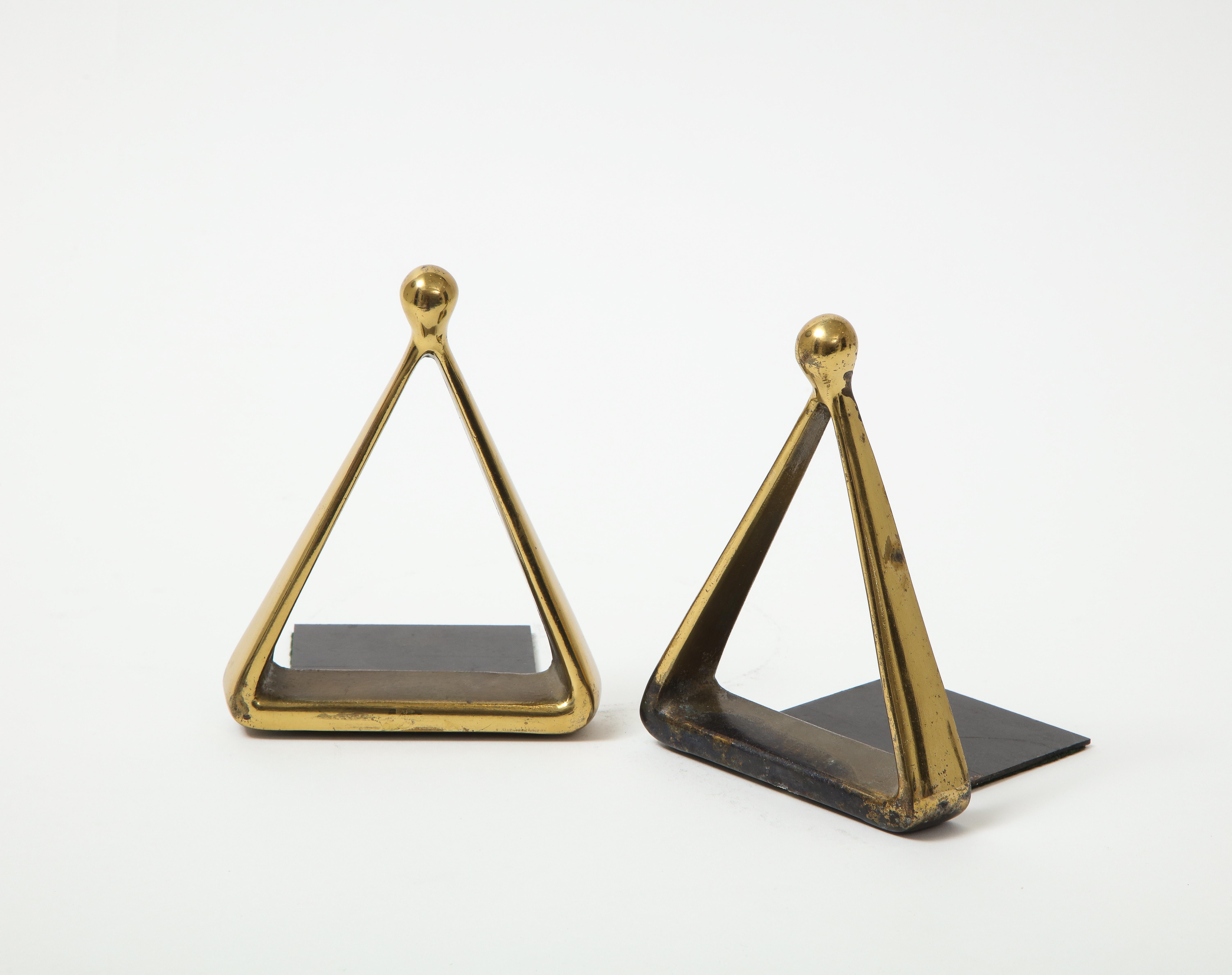 Set of aged brass triangle form bookends designed by Ben Sibel.