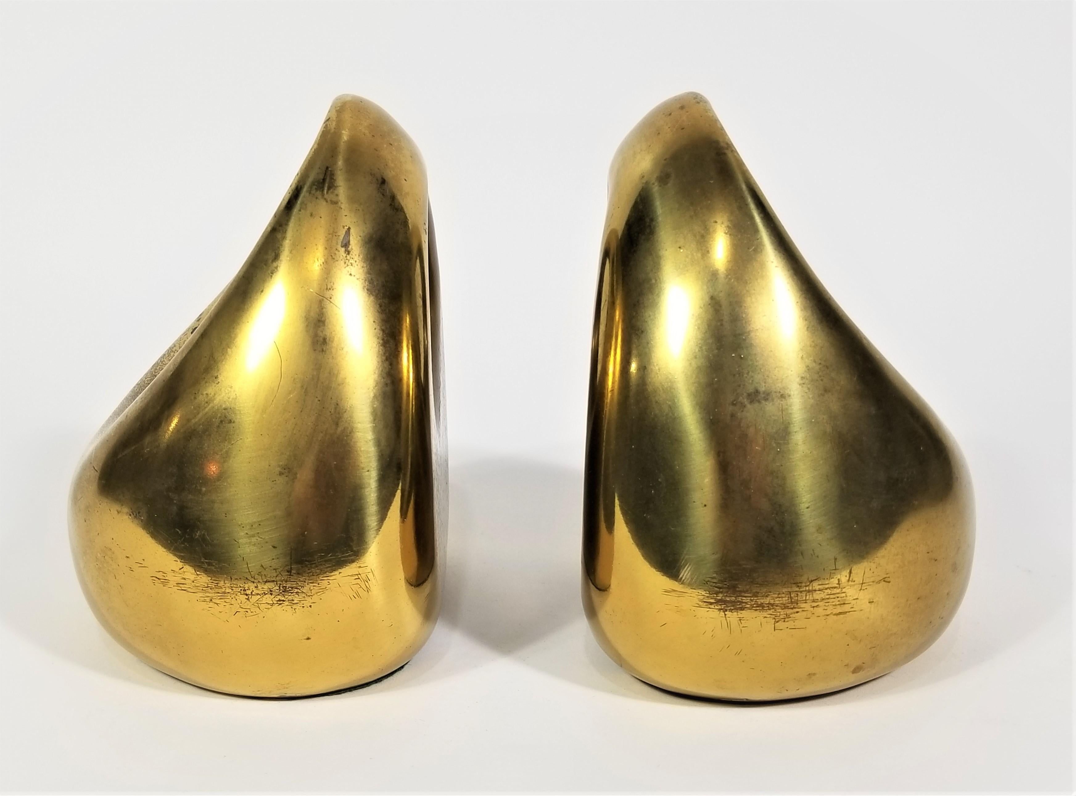 Mid Century 1960s Brass Bookend. Ben Seibel designed for Raymor. Still retains original marking sticker and felt bottom. Modern sculptural design. Some wear to finish consistent with age as shown in photos.
