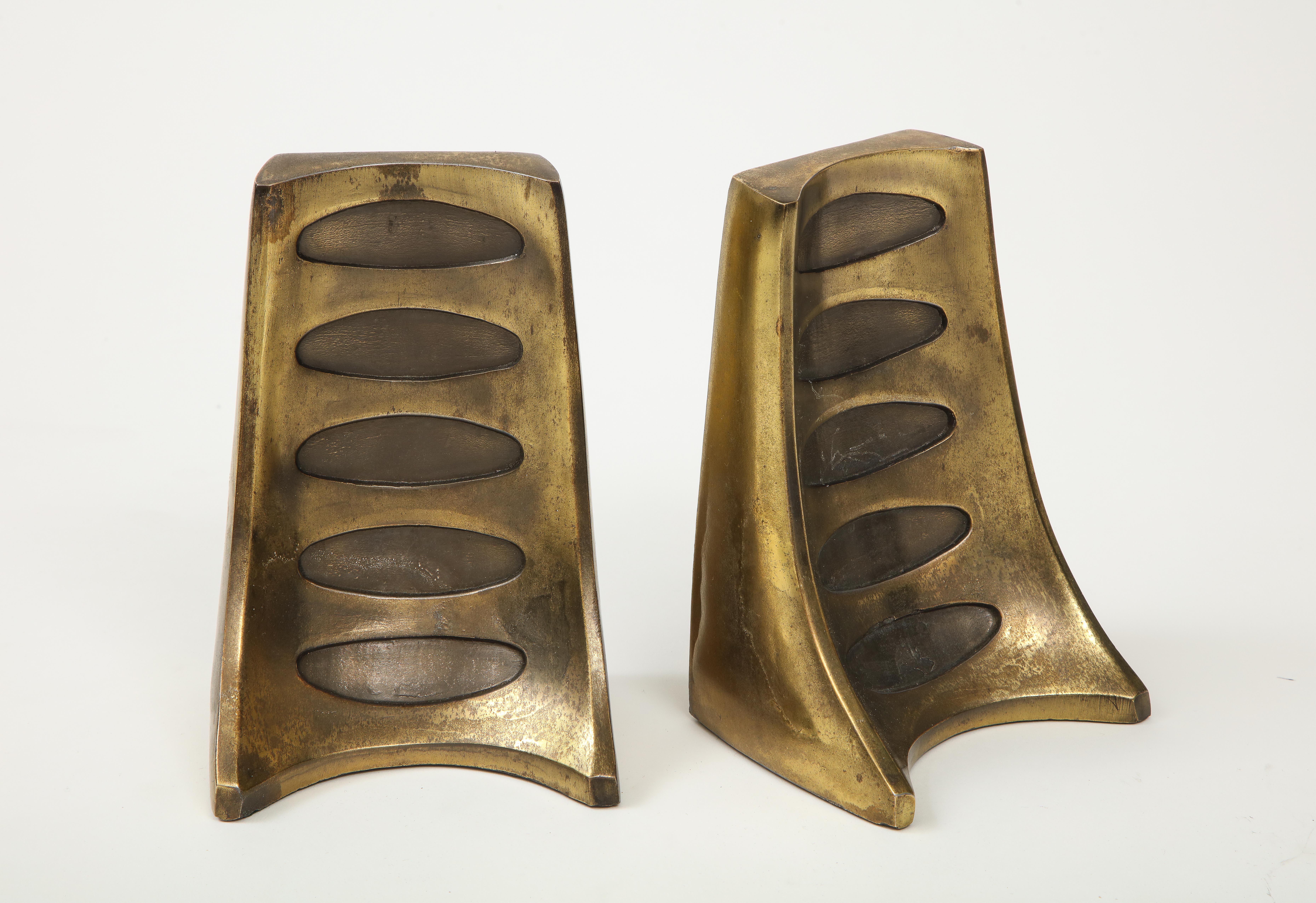Modernist bronze bookends by Ben Seibel featuring a modified tail light design.