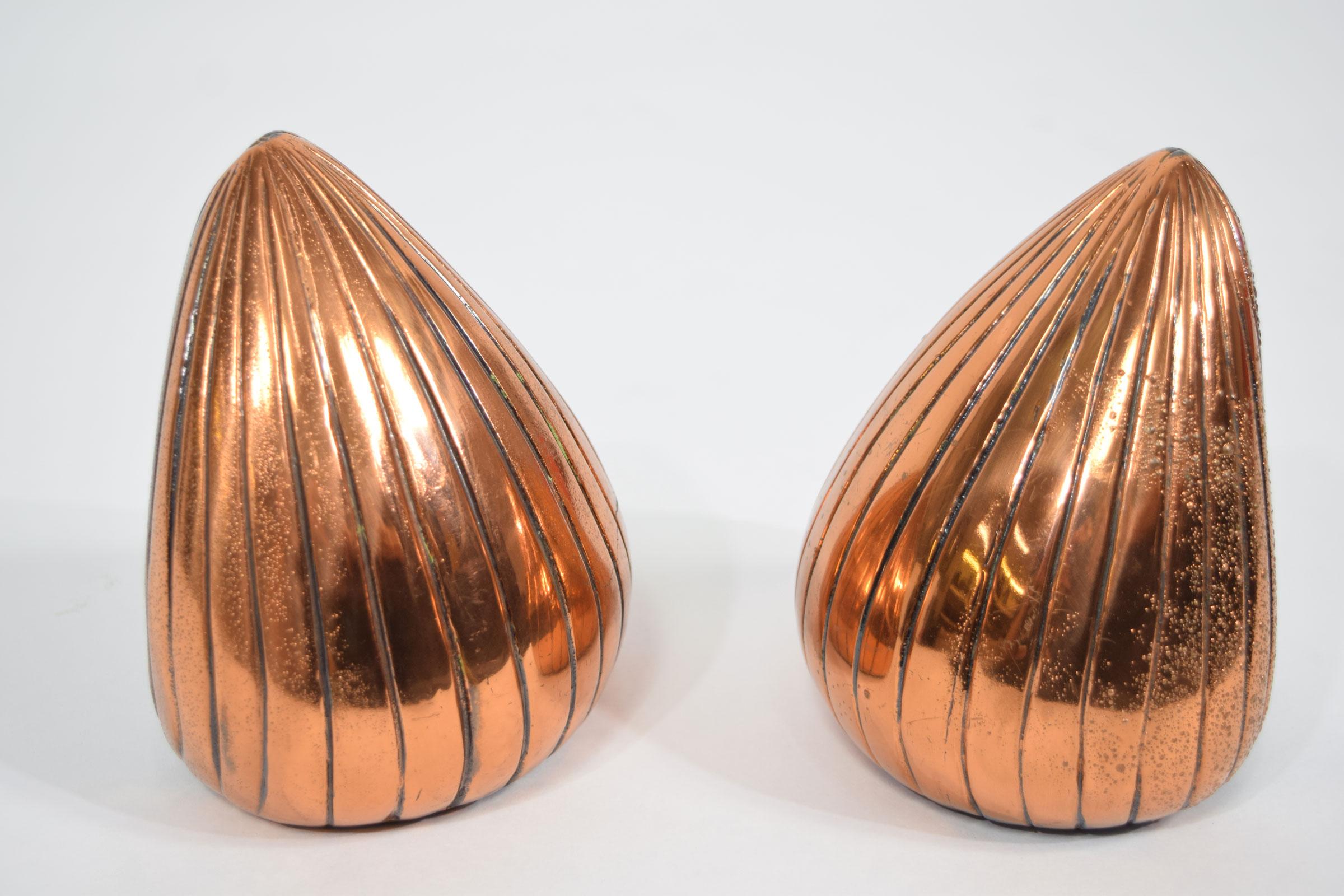 Heavy bookends by Ben Seibel in a copper finish.