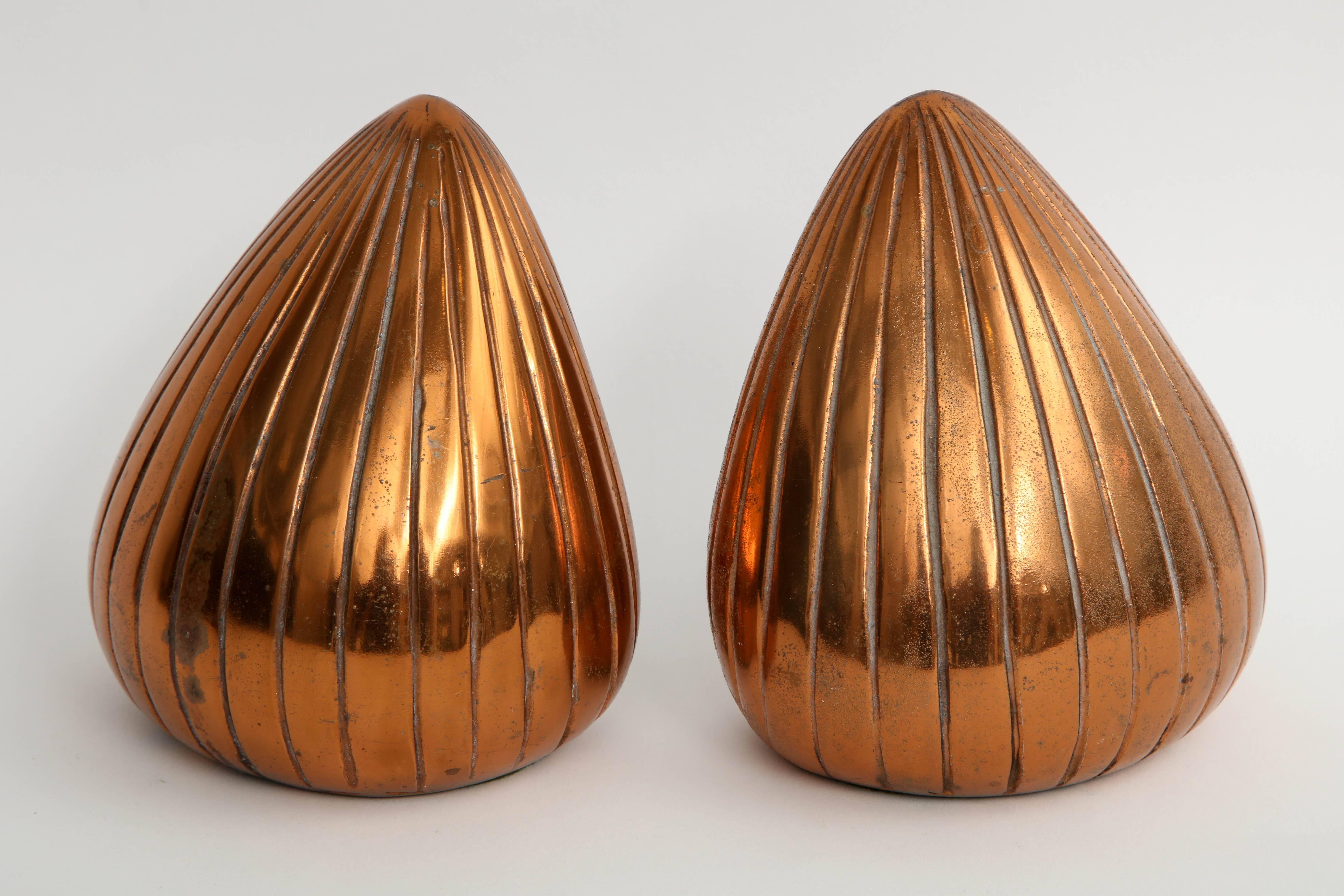 Pair of midcentury orb shaped bookends in a copper finish and incised striations.