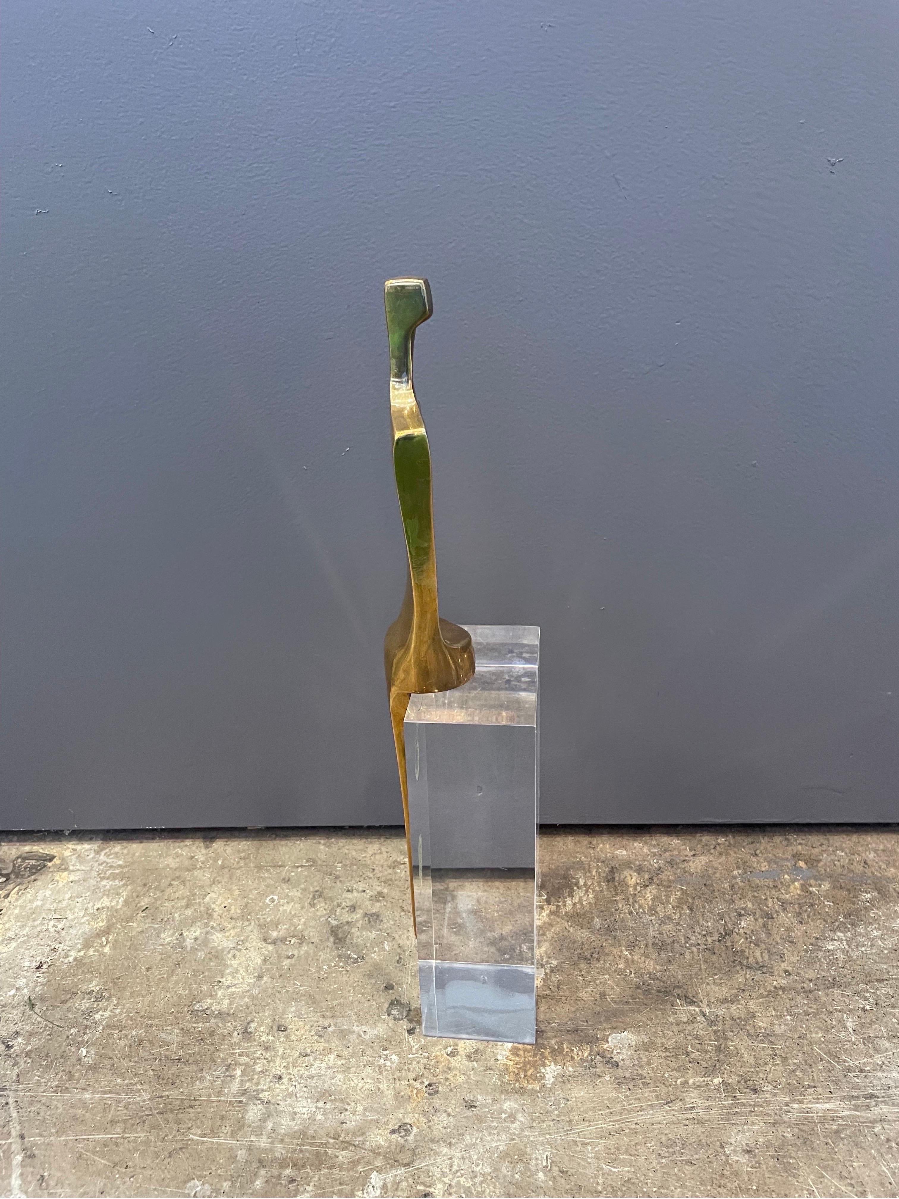 This is a Ben Shalom Bronze figure mounted on a lucite block 
It is an abstract sculpture that was 18 out of 100 made and was done in 1987.