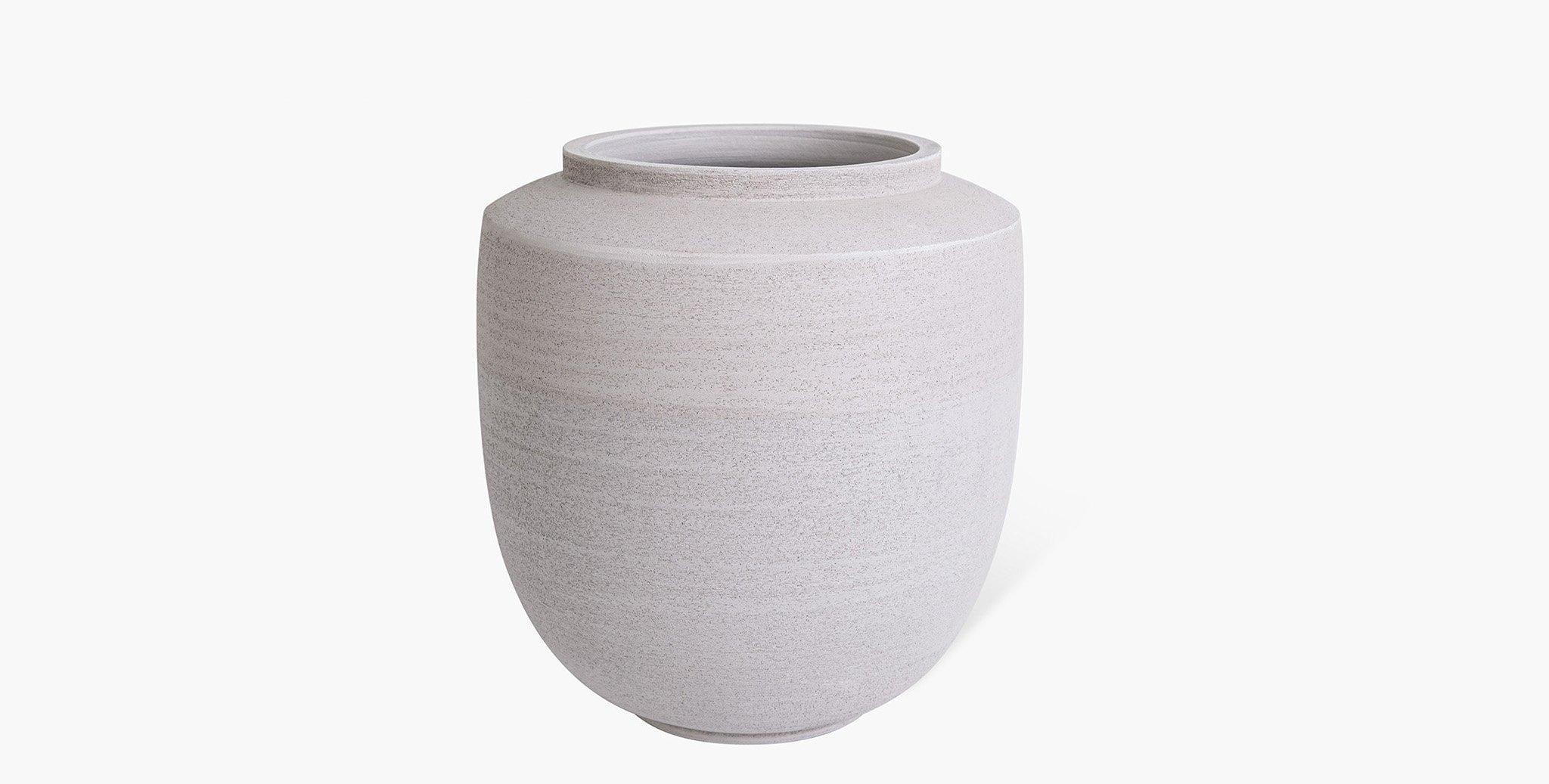 The Aeron Stoneware Vase Collection is the sublime meeting of form and function. Classic silhouettes are transformed in Stoneware clay into their most simplest form while maintaining a bold presence. A neutral earth palette was chosen to highlight