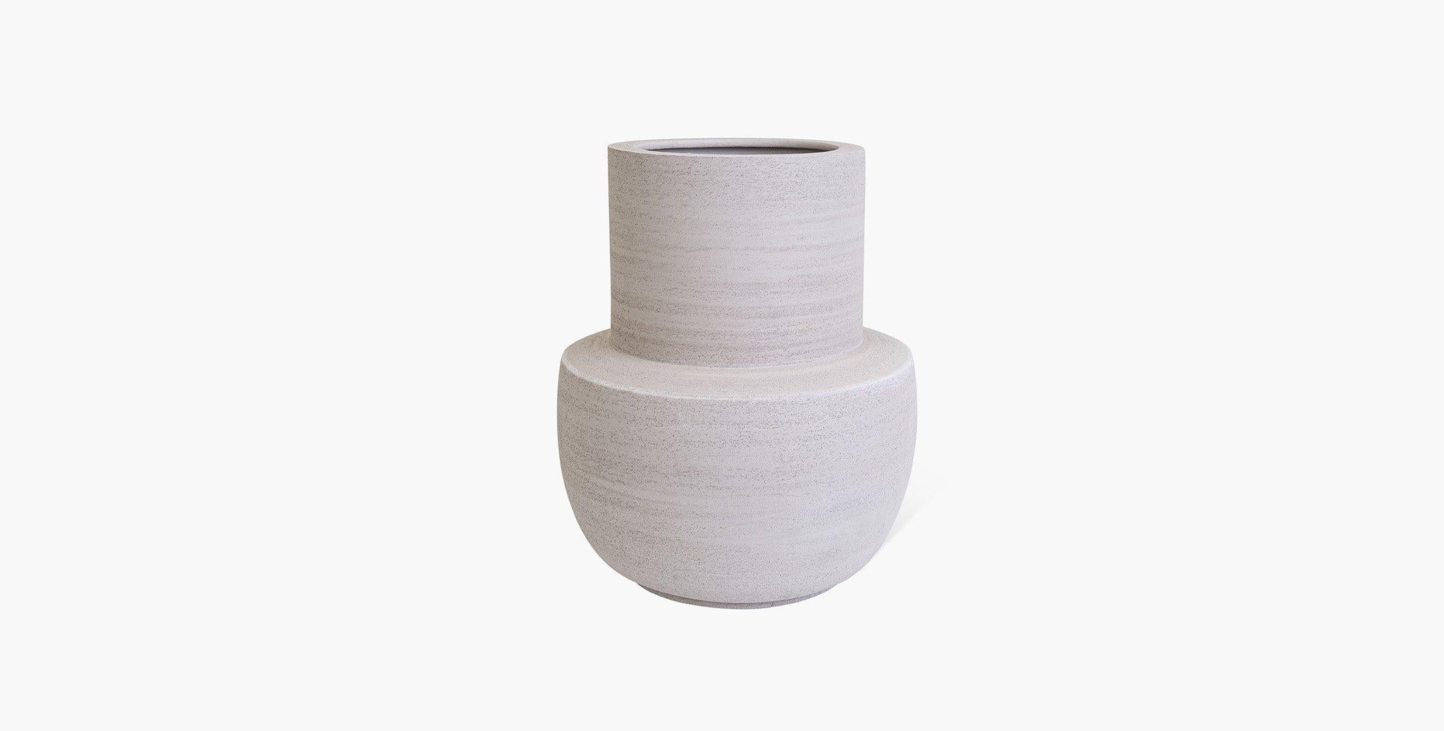 The Aeron Stoneware Vase Collection is the sublime meeting of form and function. Classic silhouettes are transformed in Stoneware clay into their most simplest form while maintaining a bold presence. A neutral earth palette was chosen to highlight