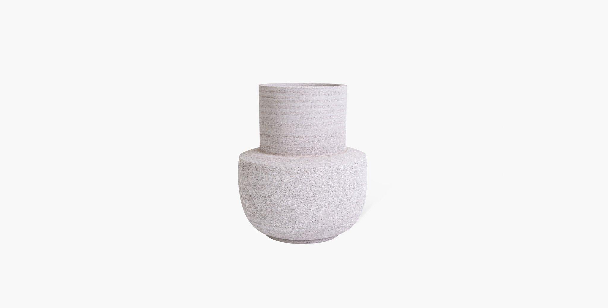 The Aeron Stoneware Vase Collection is the sublime meeting of form and function. Classic silhouettes are transformed in Stoneware clay into their most simplest form while maintaining a bold presence. A neutral earth palette was chosen to highlight