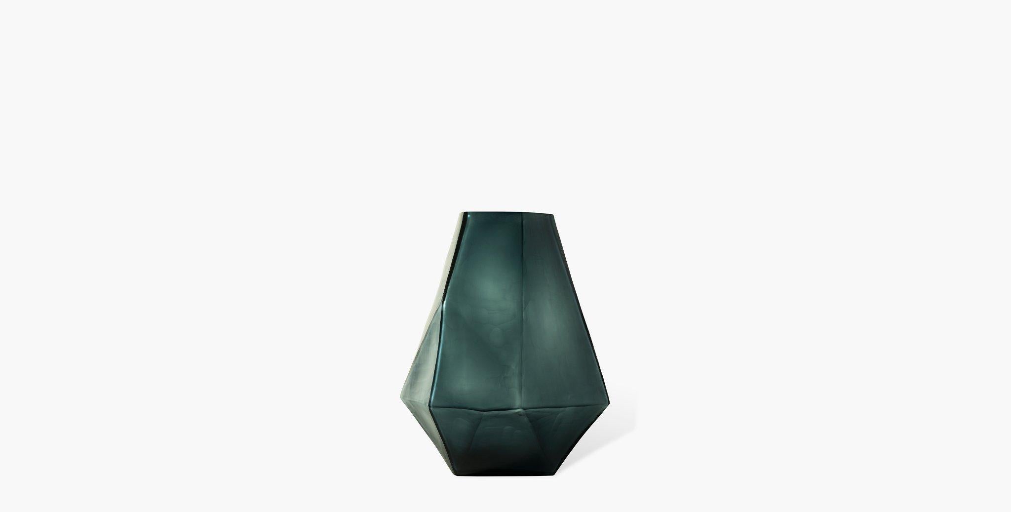 Our Arroyo Glass Vases are hand-blown and chiseled from a deep ocean blue indigo matte glass and formed into a tall diamond geometric vessel. Available in three sizes, pair with your favorite console table for a sea-inspired home
