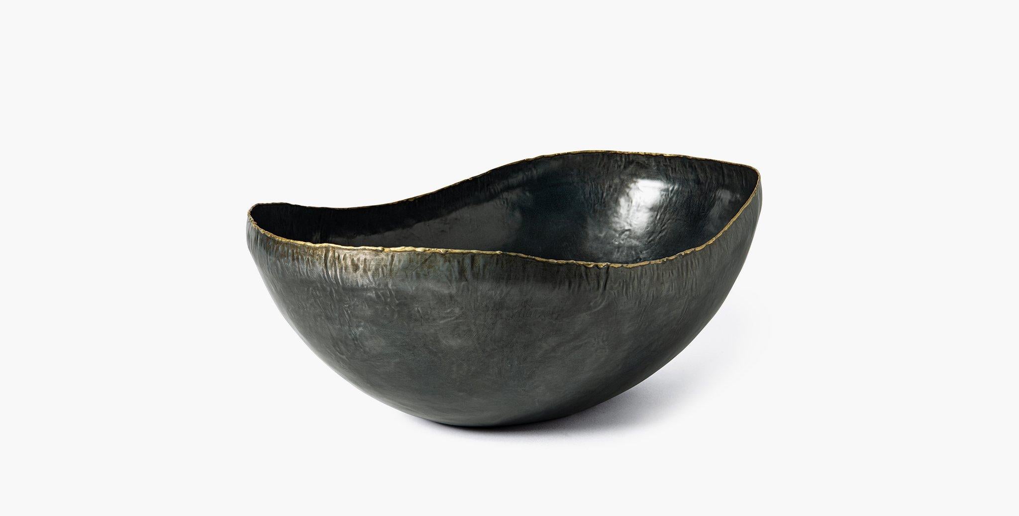 Our Vernon Bowls feature organic curves in ebonized iron with subtle metal detailing to highlight its serpentine edge. Our handcrafted fabrics, leathers, and finishes are inspired by the natural variations within fibers, textures, and weaves. Each
