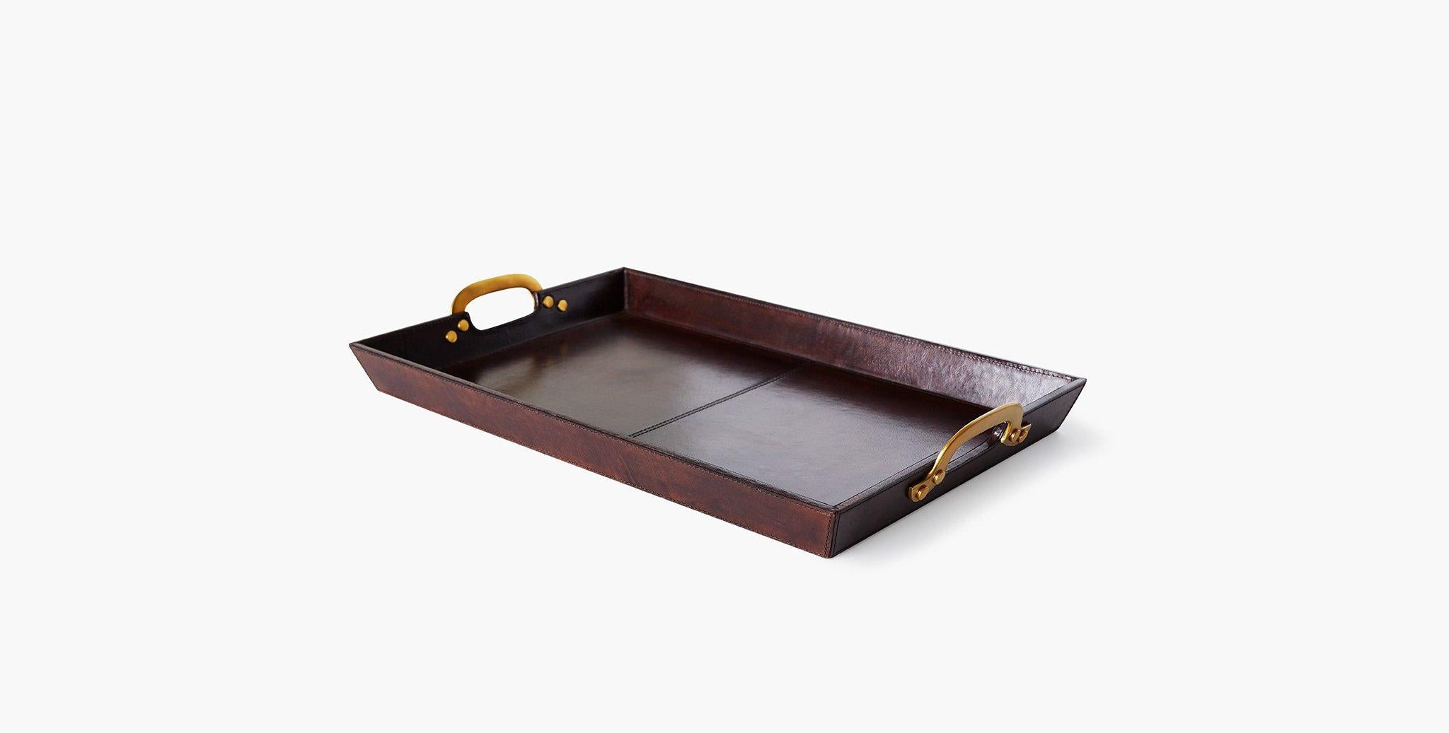 Our cade leather serving tray has riveted metal handles, providing contrast against its smooth leather frame, suitable for elevating a nightstand, counter, or coffee table display. Our handcrafted fabrics, leathers, and finishes are inspired by the