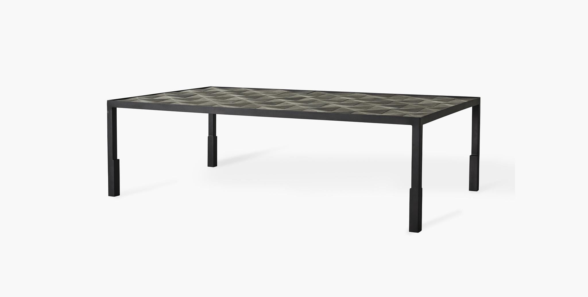 Hand-tiled in leather with an understated geometric pattern in monochrome charcoals and greys, our Calder Coffee Table adds a layered point of interest to your decor. A black metal frame provides a subtle yet substantial base. Tray not included.
