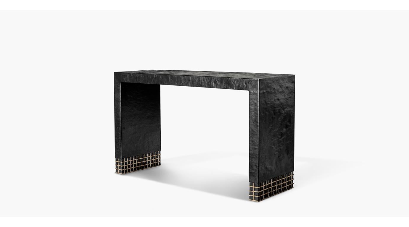 The Crawford console table creates huge visual impact with its black forged steel waterfall body appealingly contrasted with an open weave brass base detail making it an unforgettable addition to your space.
  