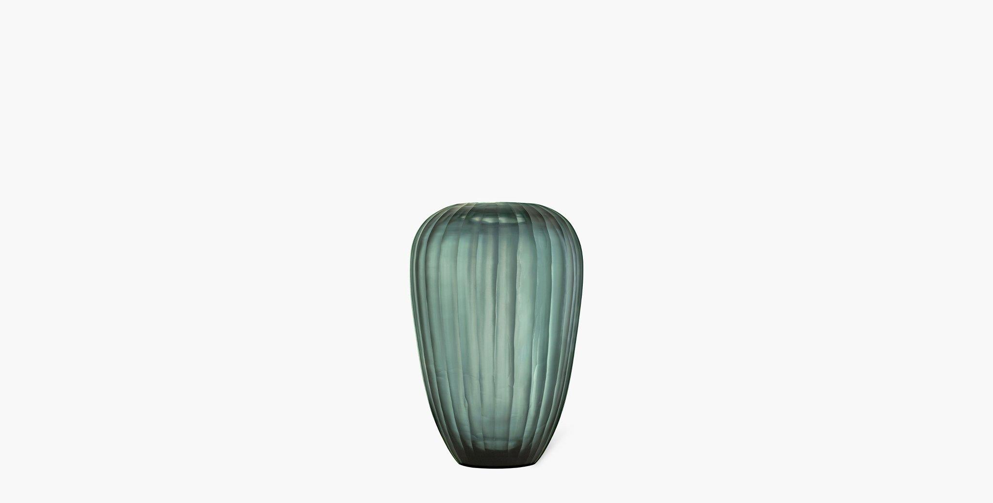 Our Grove Glass Vases feature a beautiful translucent matte indigo color that is reminiscent of sea glass.

Glass
Imported