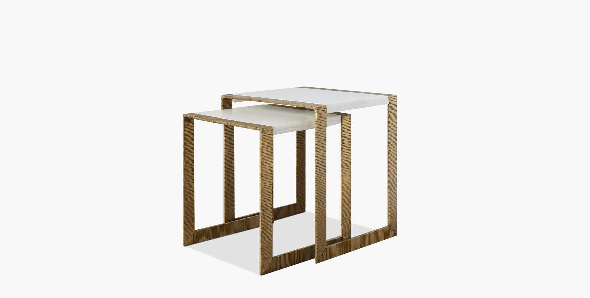 The svelte Hawthorn nesting tables have an open brass U-leg base with clean lines paired with a contemporary white stone with chiseled edges.

Dimensions:
Large table width 20”, depth 18”, height 22.25”
Small table width 18”, depth 117.75”,