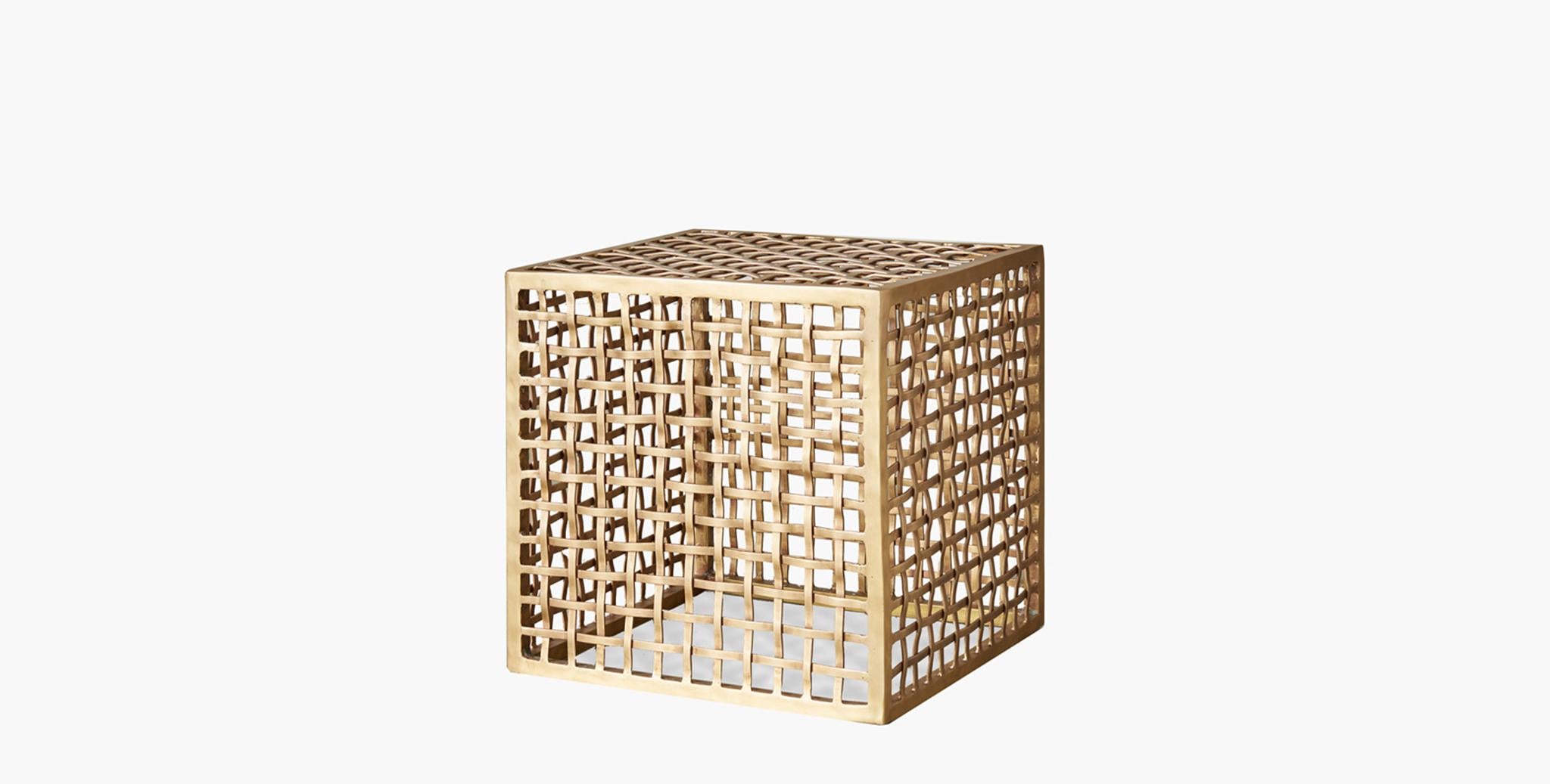 The Lennox side table is exquisite with its brass weave, cube silhouette handwoven by master artisans. The open weave creates an airy effect while remaining a solid statement piece.
  