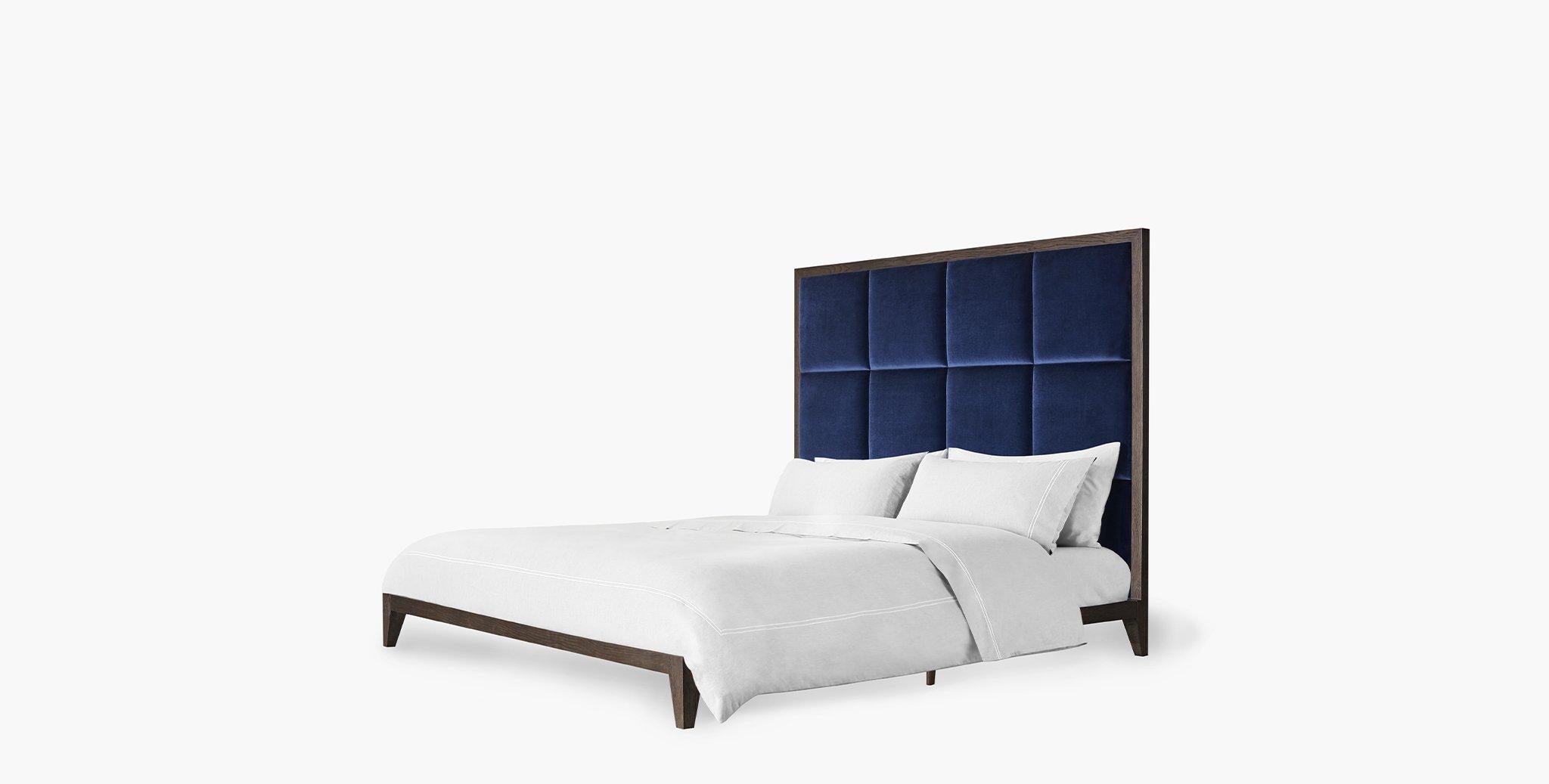 Exquisitely crafted with a tufted panel headboard perched on a dark walnut low-profile platform base, the Ridley bed is a refined anchor for a tailored retreat. Size: Queen. Upholstered with velvet sapphire fabric.
 