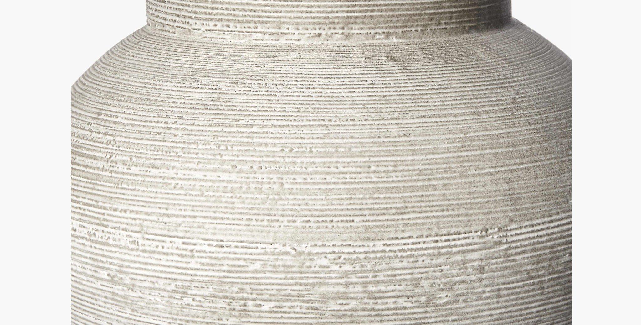 The hand-made Shaw Indoor / Outdoor Vase features an abstract shape and etched ribbed lines throughout, offering a rustic point of interest.

Hand-molded and painted
Made of clay and stone powder
Imported
Vessels must be kept under a covered