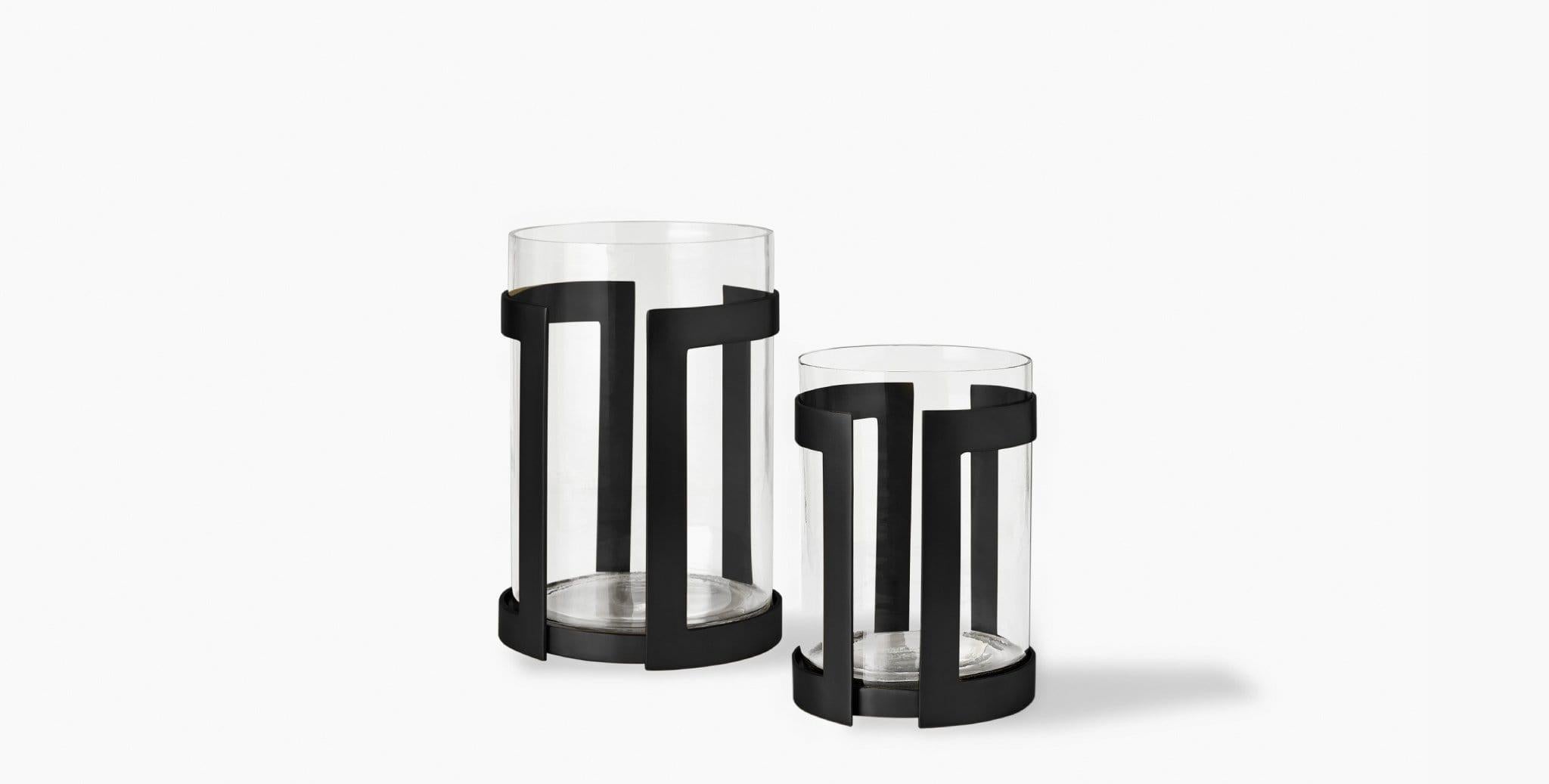 Our Thorne Hurricane Candle Holder brilliantly showcases the glow of pillar candles in its minimal metal frame paired with a glass insert. Our handcrafted finishes are inspired by variations within natural textures. Each selection is slightly