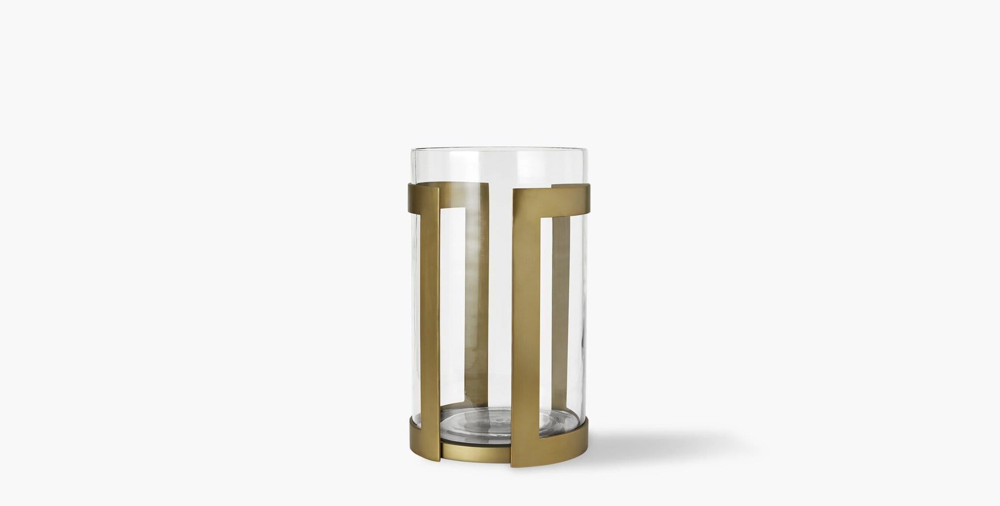 Our Thorne Brass Hurricane Candle Holder brilliantly showcases the glow of pillar candles in its minimal brass frame paired with a glass insert. Our handcrafted finishes are inspired by variations within natural textures. Each selection is slightly