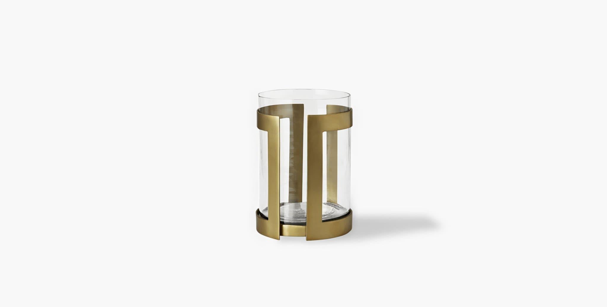 Our Thorne Brass Hurricane Candle Holder brilliantly showcases the glow of pillar candles in its minimal brass frame paired with a glass insert. Our handcrafted finishes are inspired by variations within natural textures. Each selection is slightly