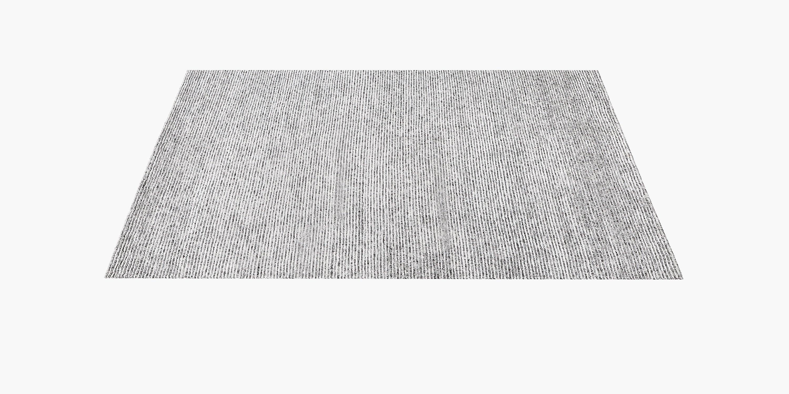 Master artisans hand-weave this luxurious rug from soft blended New Zealand wool, alternating stripes of pile and loops to create its distinctive texture. Marbled yarns create varying tones in the loops, while the ivory pile is cut to an even