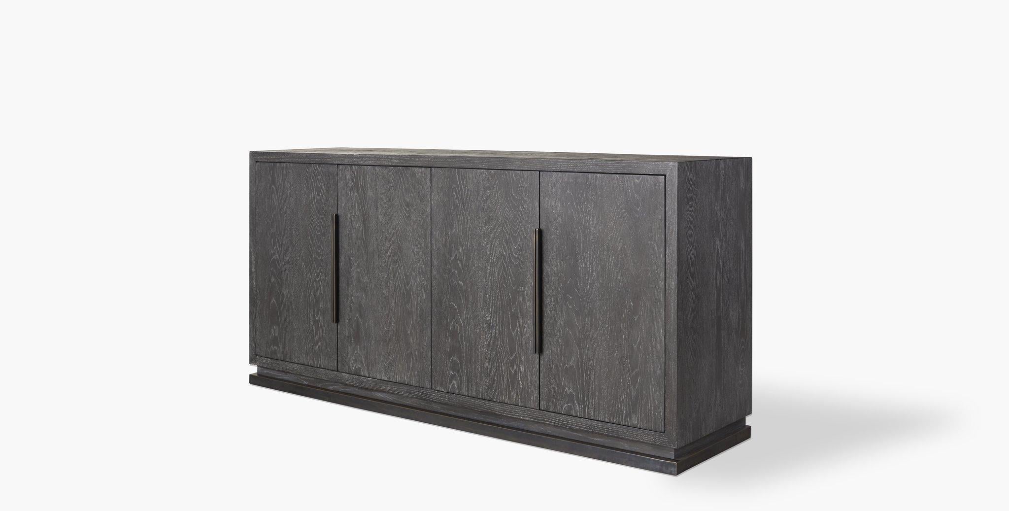 Our woods credenza's minimal silhouette sits on a plinth base featuring latch doors that open to shelving, perfect for dining rooms, living rooms, and entryway. Our handcrafted finishes are inspired by the natural variations within fibers, textures,