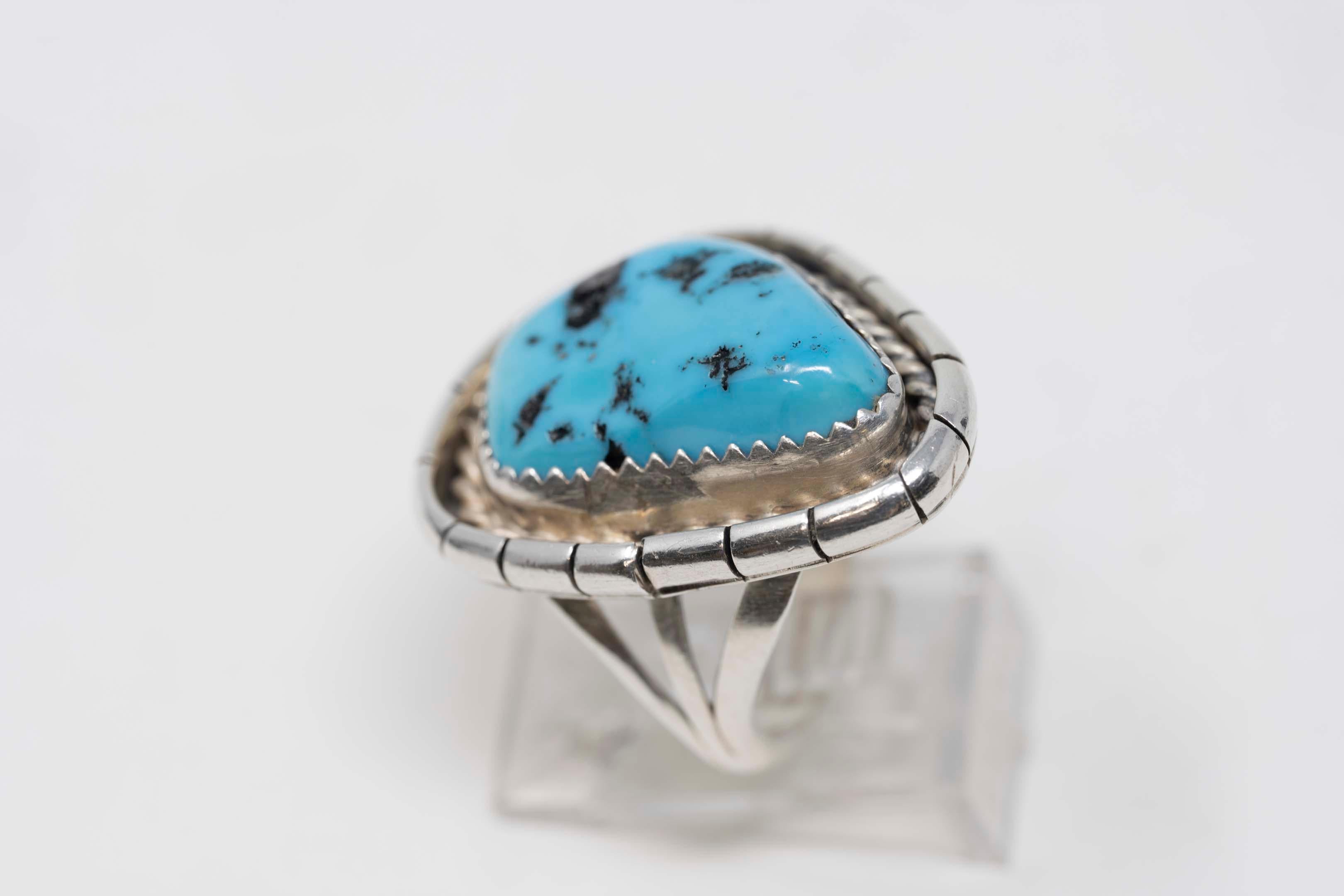 Native American Navajo Ben Yazzie sterling silver ring and turquoise stone size 7 1/2. Signed inside, top measures 27mm x 22mm, turquoise measures 21mm x 14mm. In good condition.

