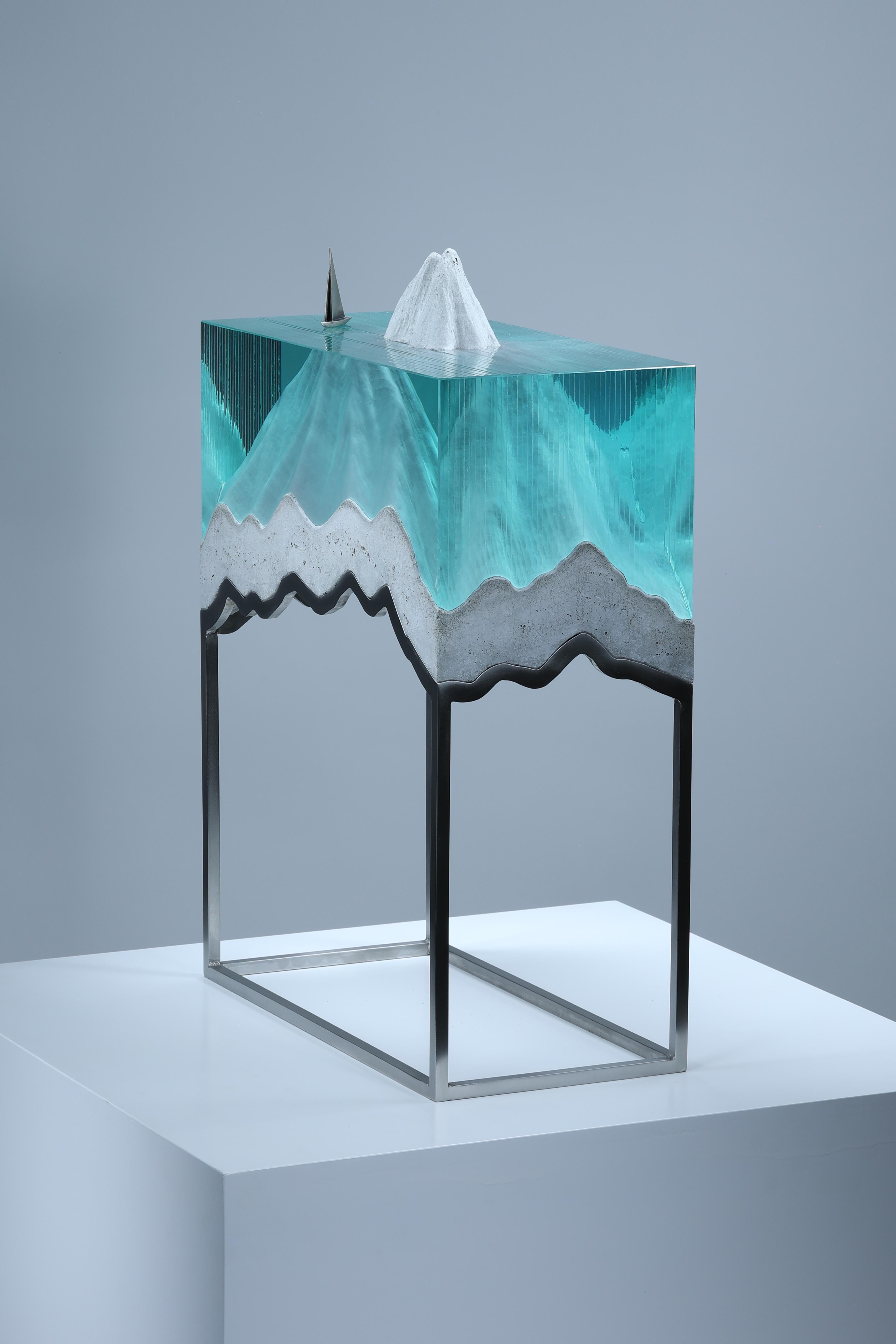Ben Young’s sculpture fluidly blends glass, concrete, bronze, steel, and light to depict romantic and pensive imagery highlighting the fragility of our climate and its most precious resource – water. Born in Australia and raised in New Zealand,