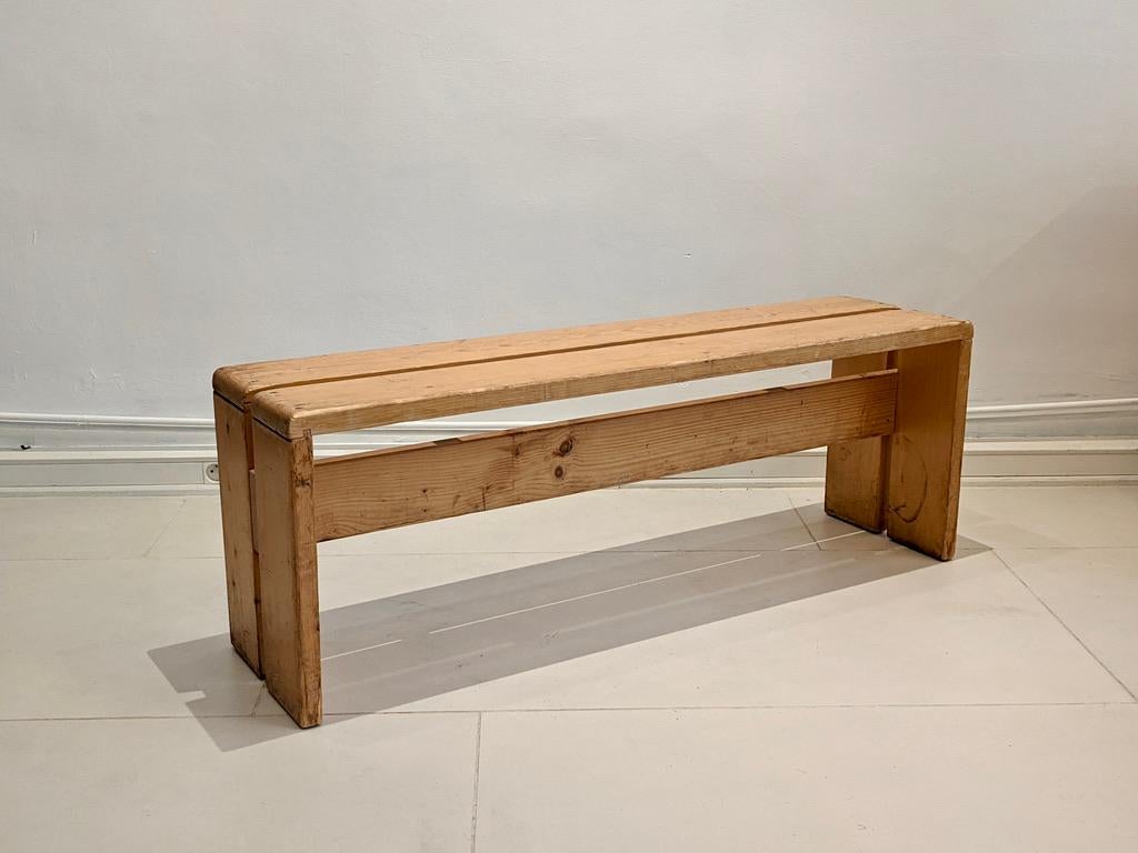 Bench in pinewood by Charlotte Perriand for Les Arcs. Light wear on the wood and the screws consistent with age and use.