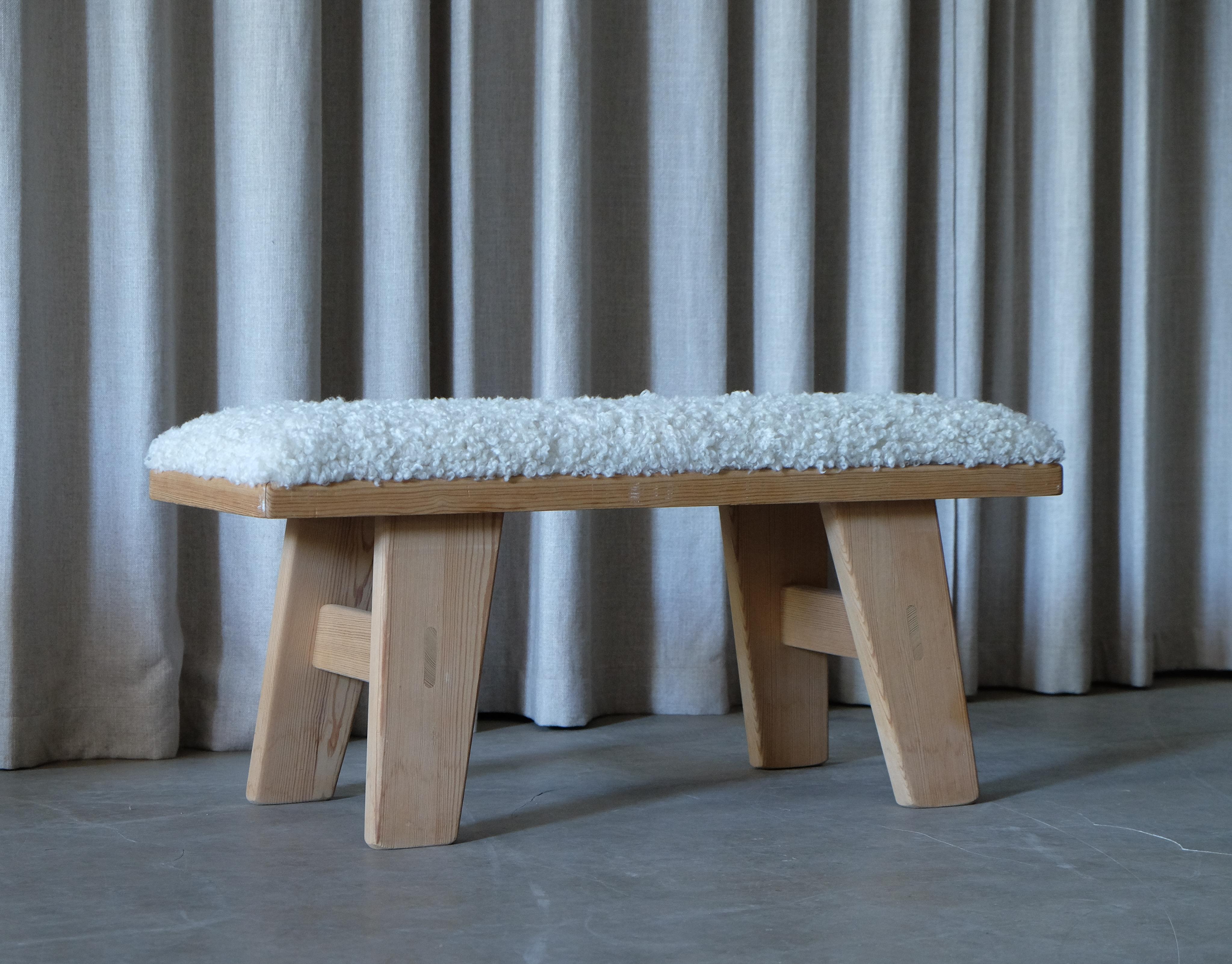 Pine bench by Krogenäs, newly upholstered in sheepskin. Produced in Norway.