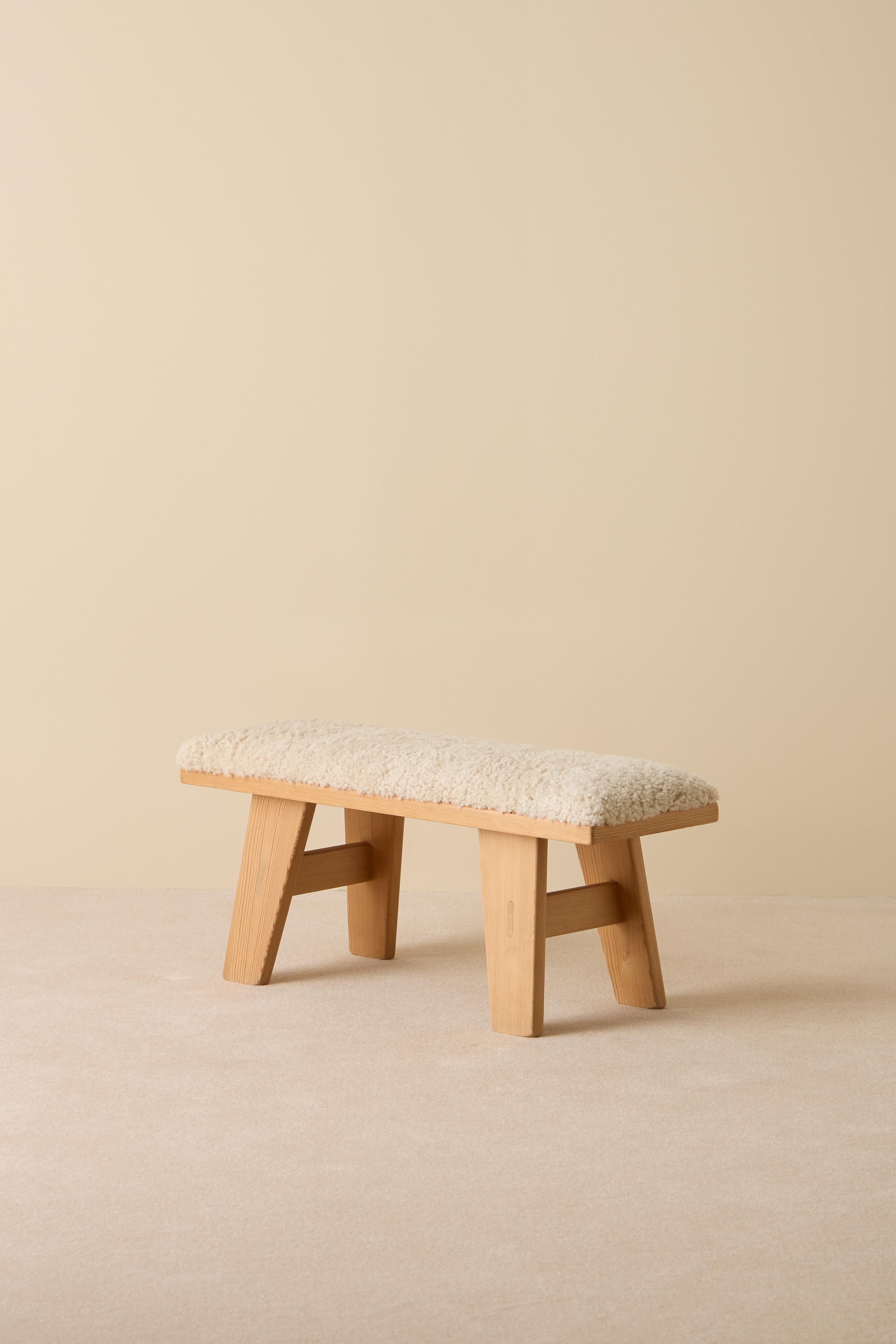 Pine bench by Krogenäs, newly upholstered in sheepskin. Produced in Norway.