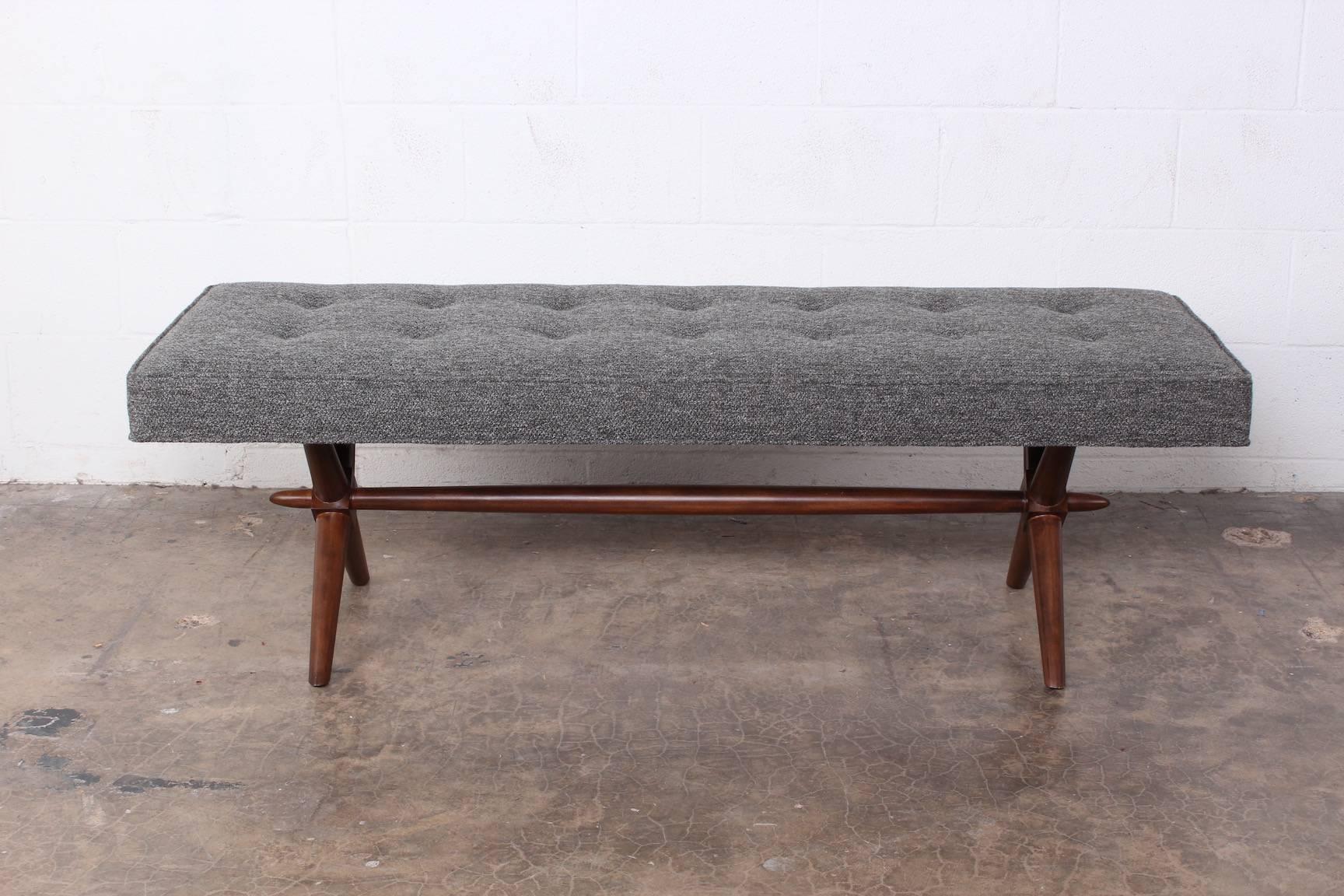 A walnut bench designed by T.H. Robsjohn-Gibbings for Widdicomb.
 