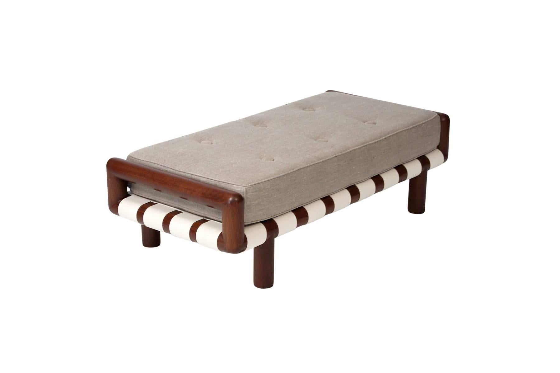 Large upholstered bench by T.H. Robsjohn-Gibbings for Widdicomb. Walnut frame with woven canvas strapping. Iconic series by the noted American designer.